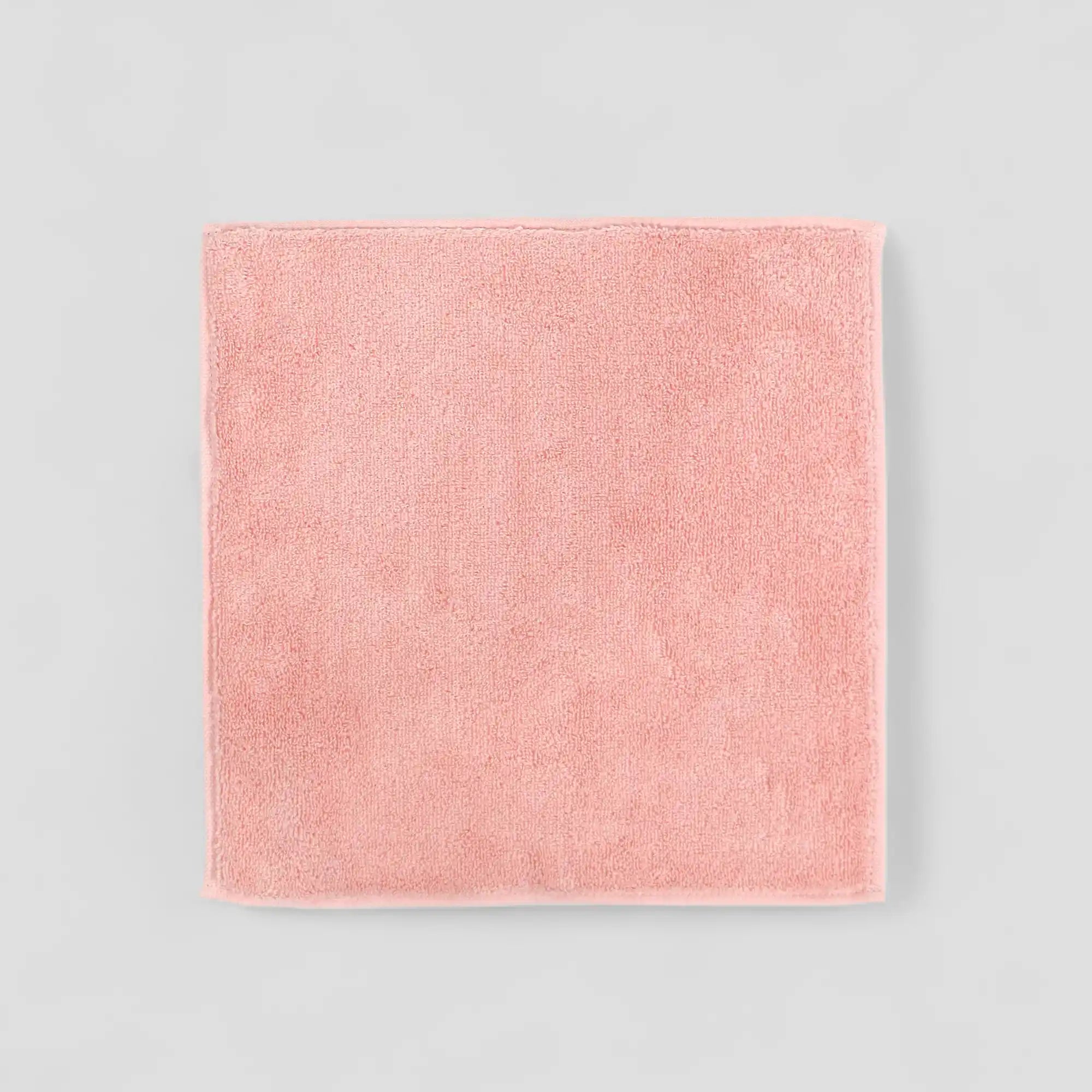Pink Imabari towel on a gray background