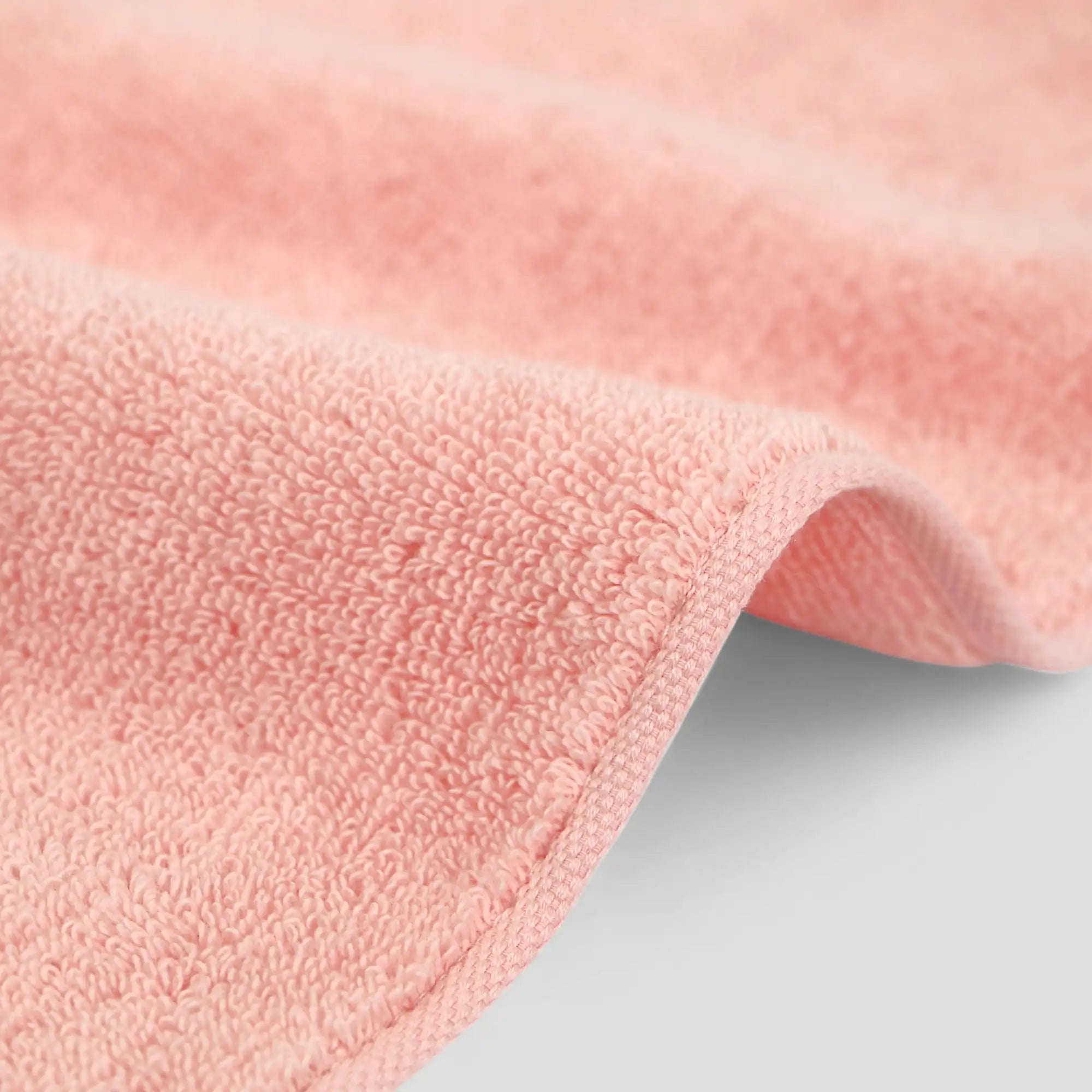 Close-up of a pink Imabari towel on a light gray background