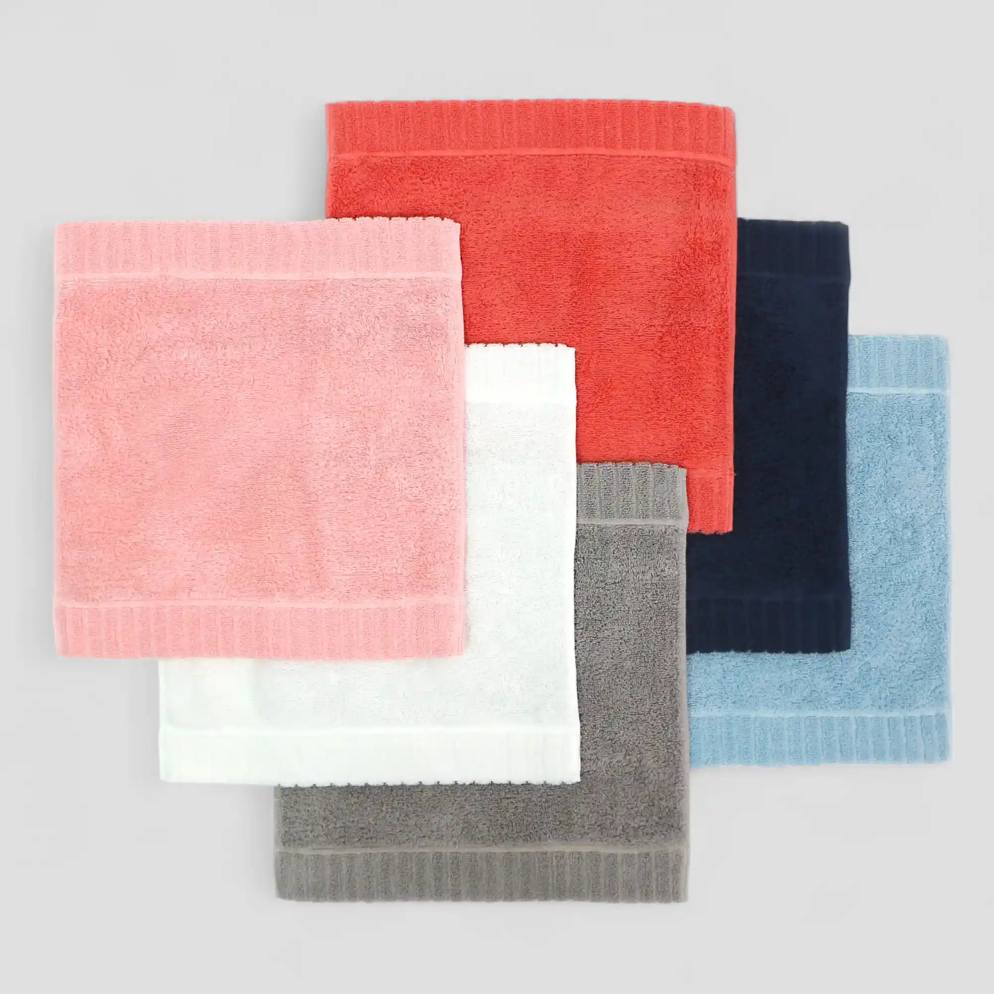Set of colorful Imabari towels stacked on a light gray background
