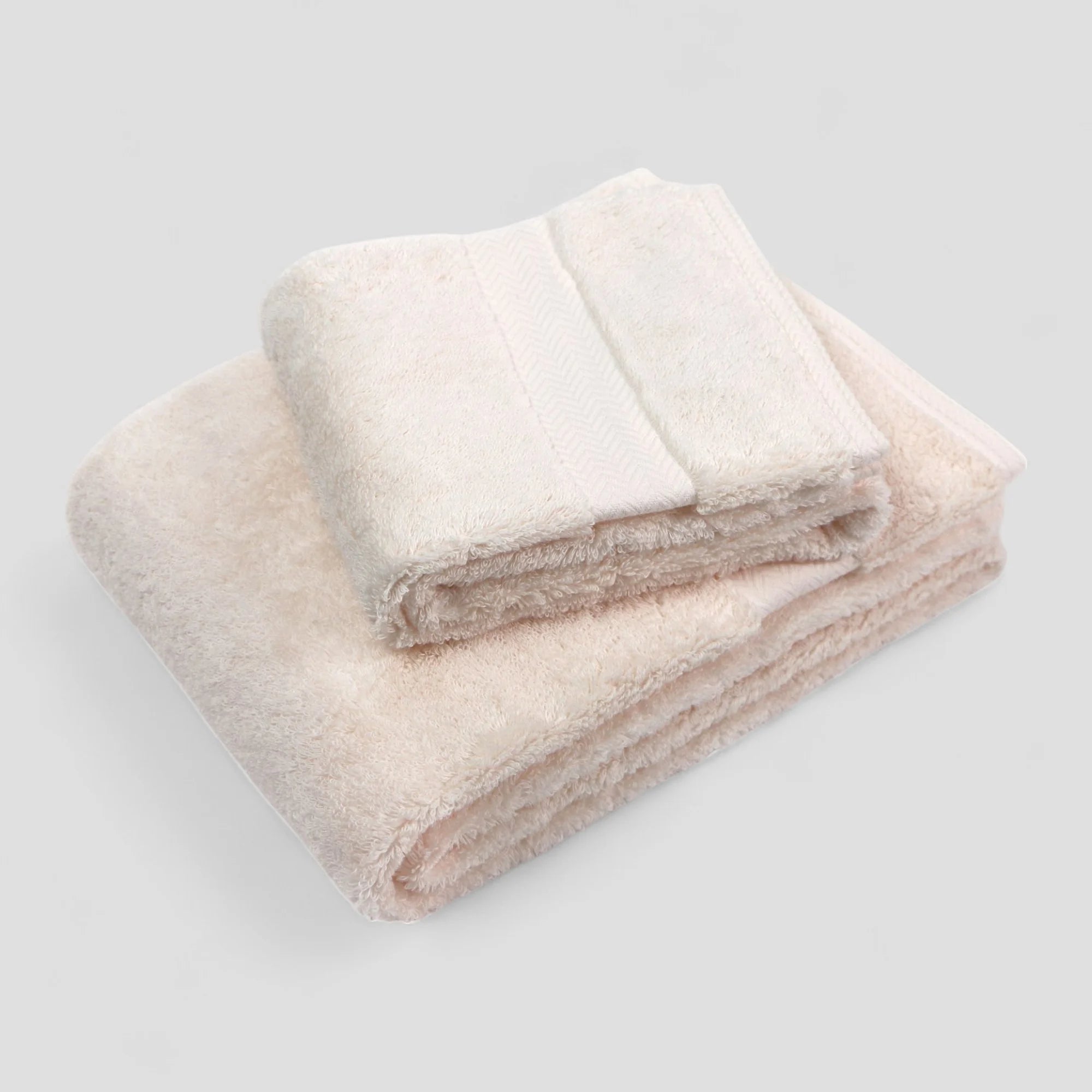 Folded pink Imabari Towel on a light gray background