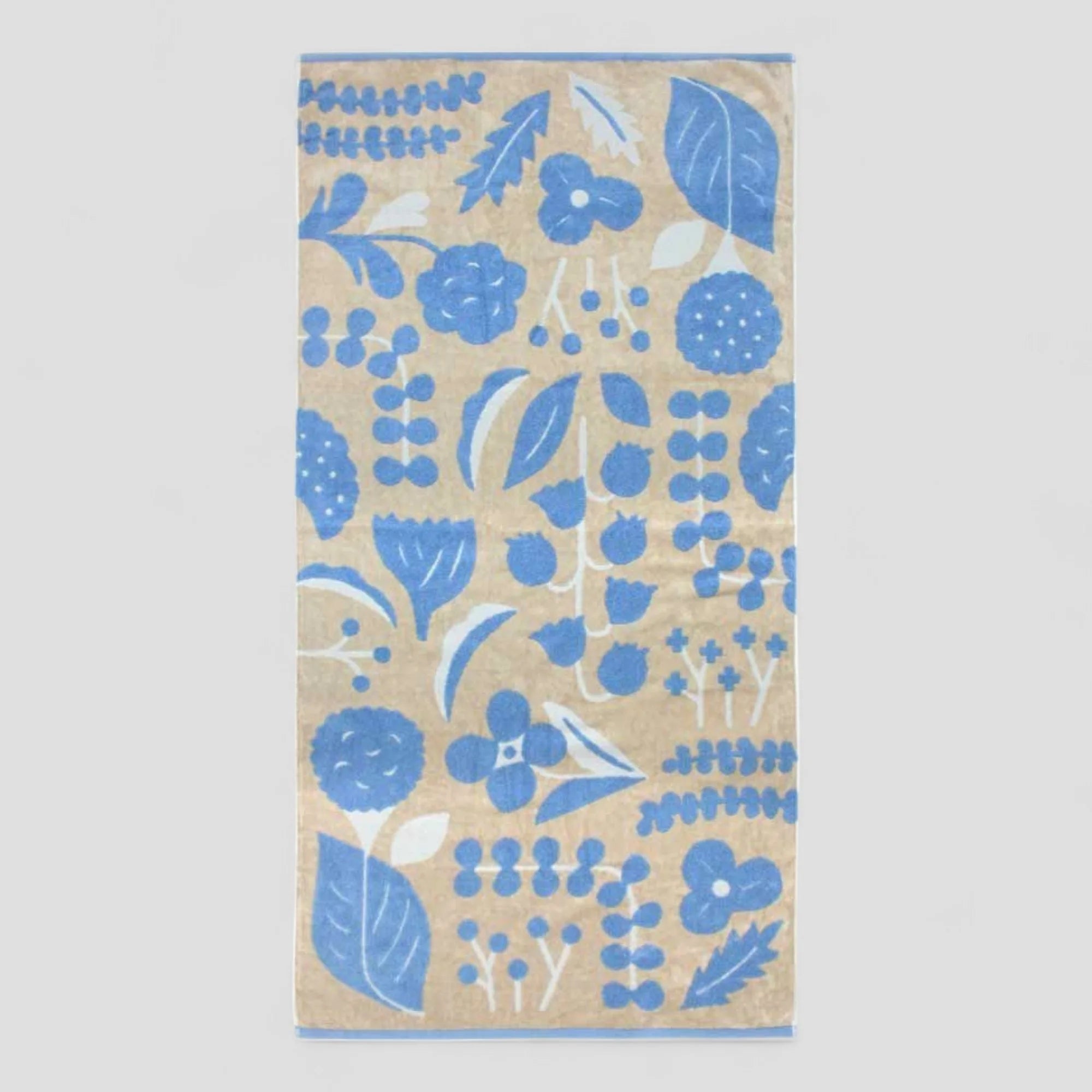 Beige Imabari towel with blue floral pattern on a white background