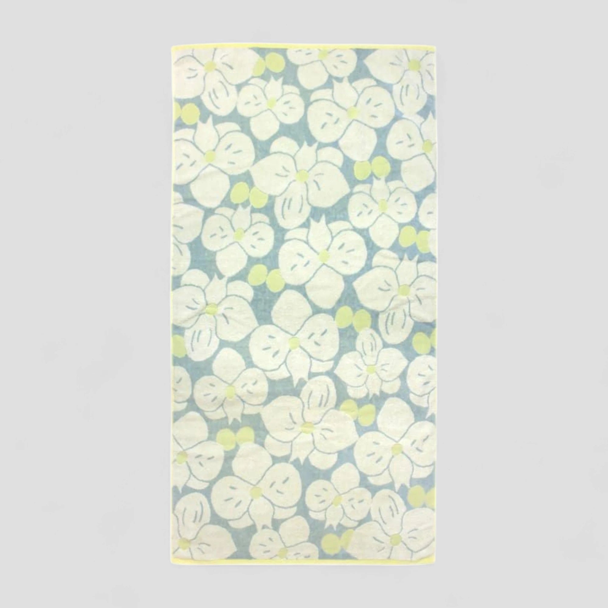 Floral patterned Imabari towel with white flowers on a light blue background