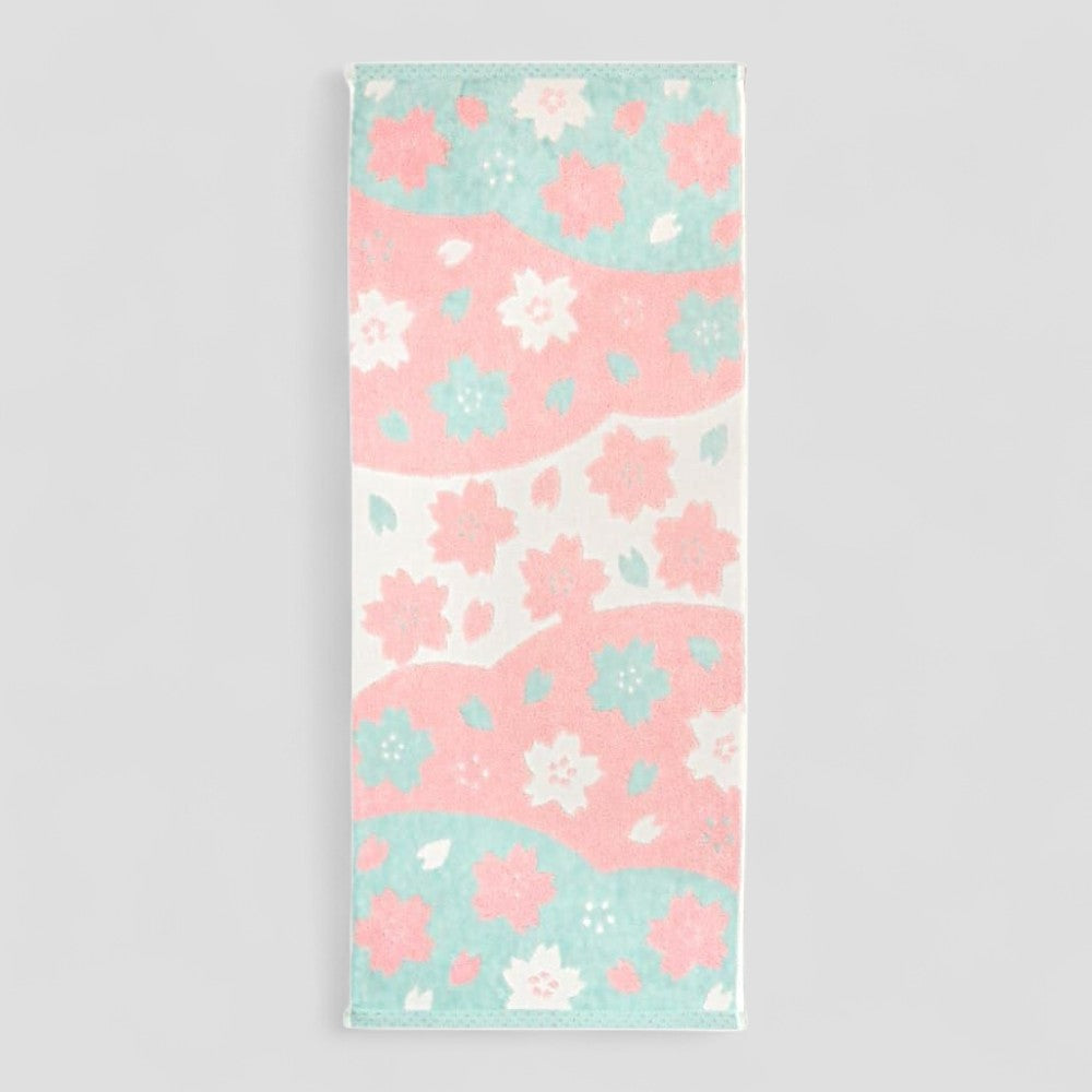 Floral patterned Imabari towel with pink and blue flowers on a light gray background