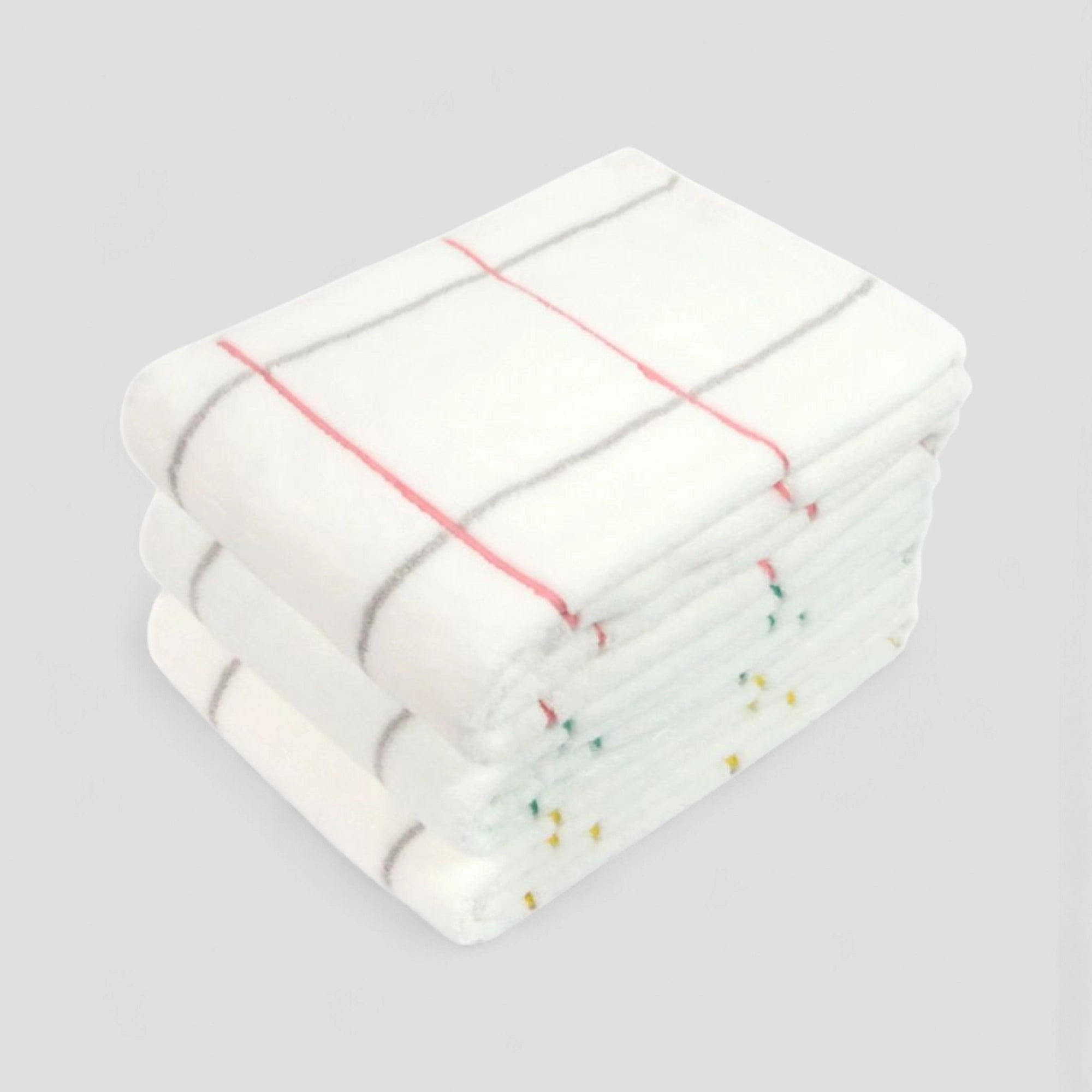 Stack of folded white towels with colorful lines on a light gray background