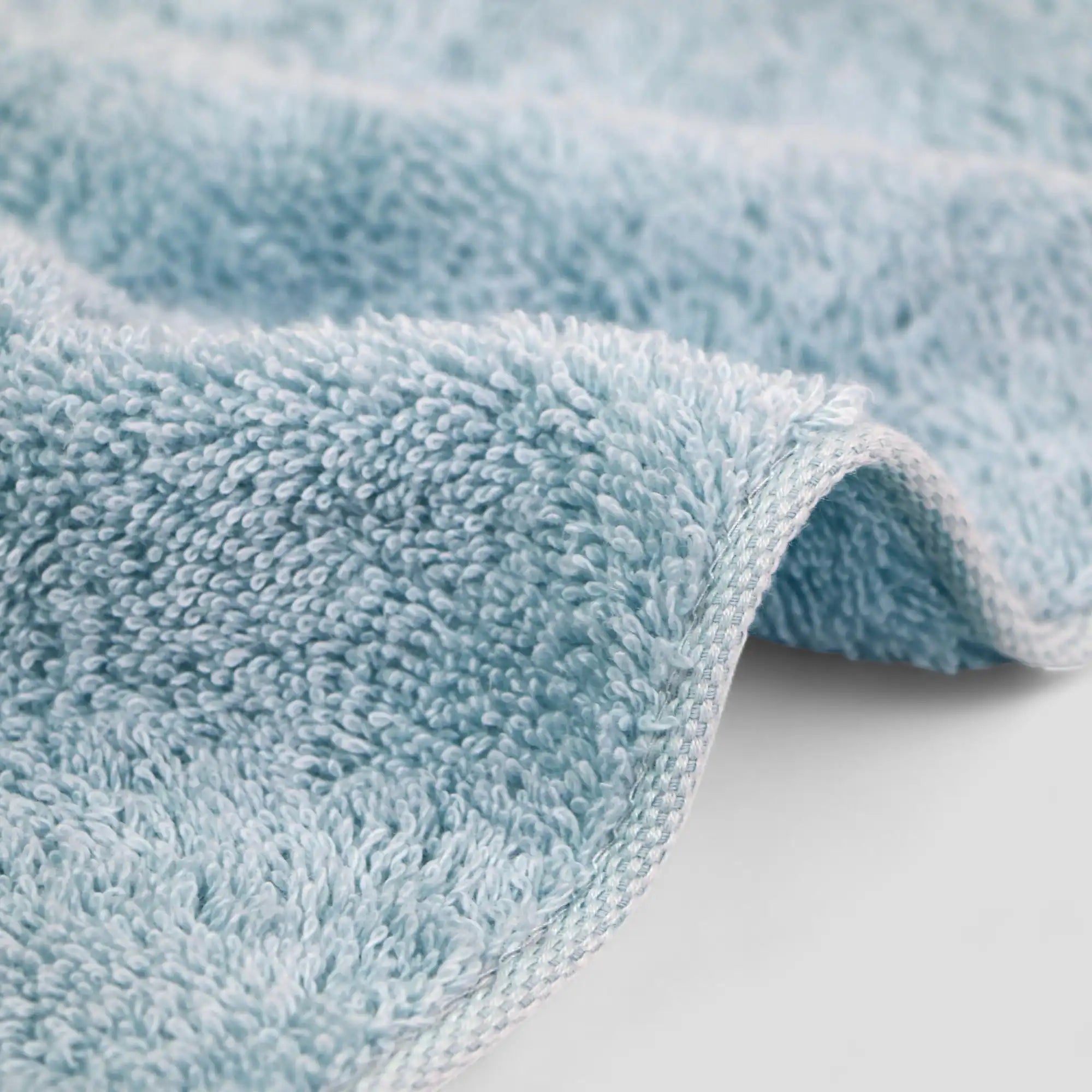 Close-up of a light blue textured Imabari towel on a white background