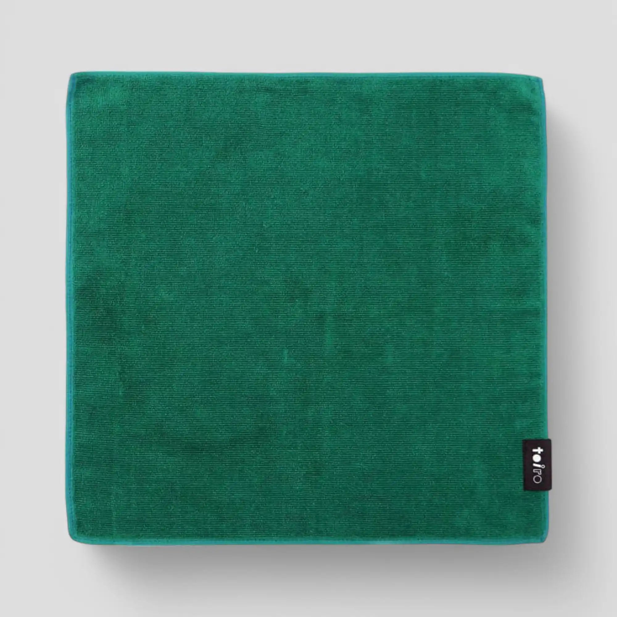 A square green Imabari towel displayed light-gray background