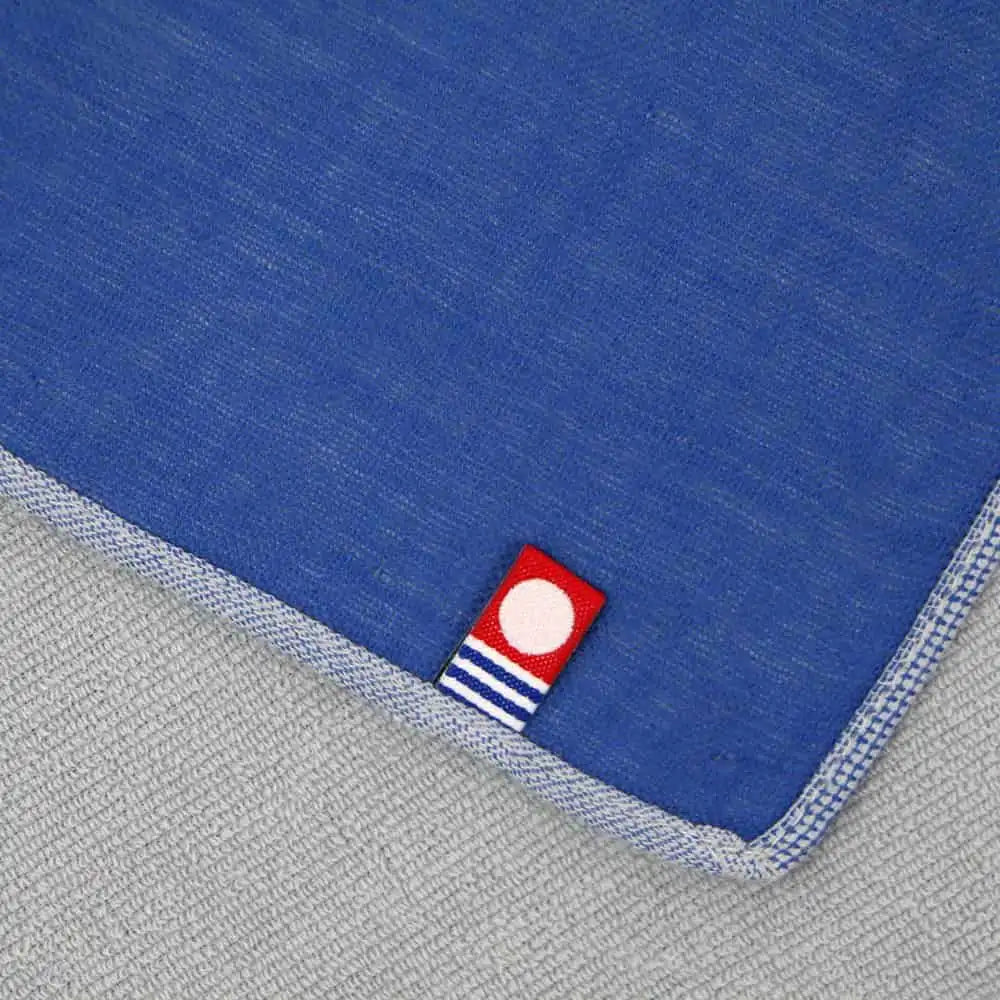 Close up of a label of Iambari towel brand mark