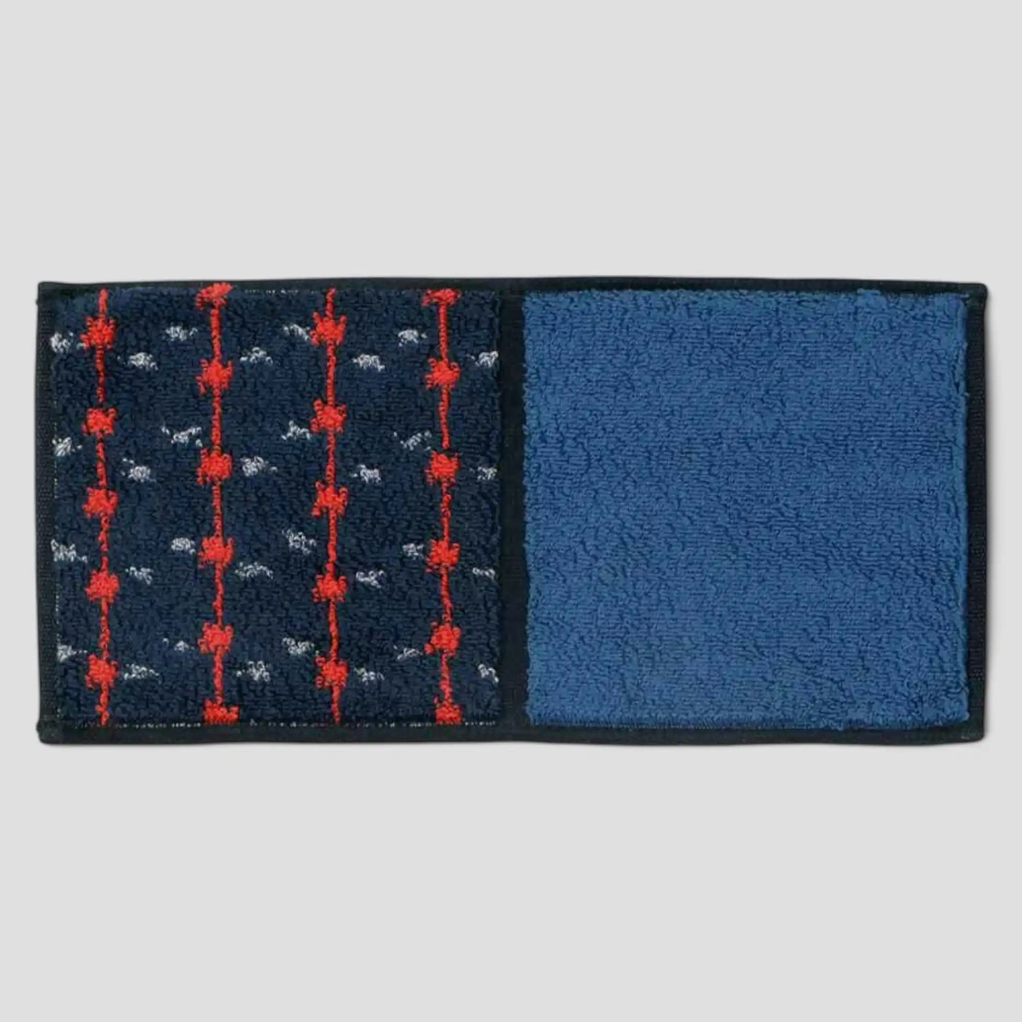 A Imabari towel in blue with red pattern, displayed against a white background.