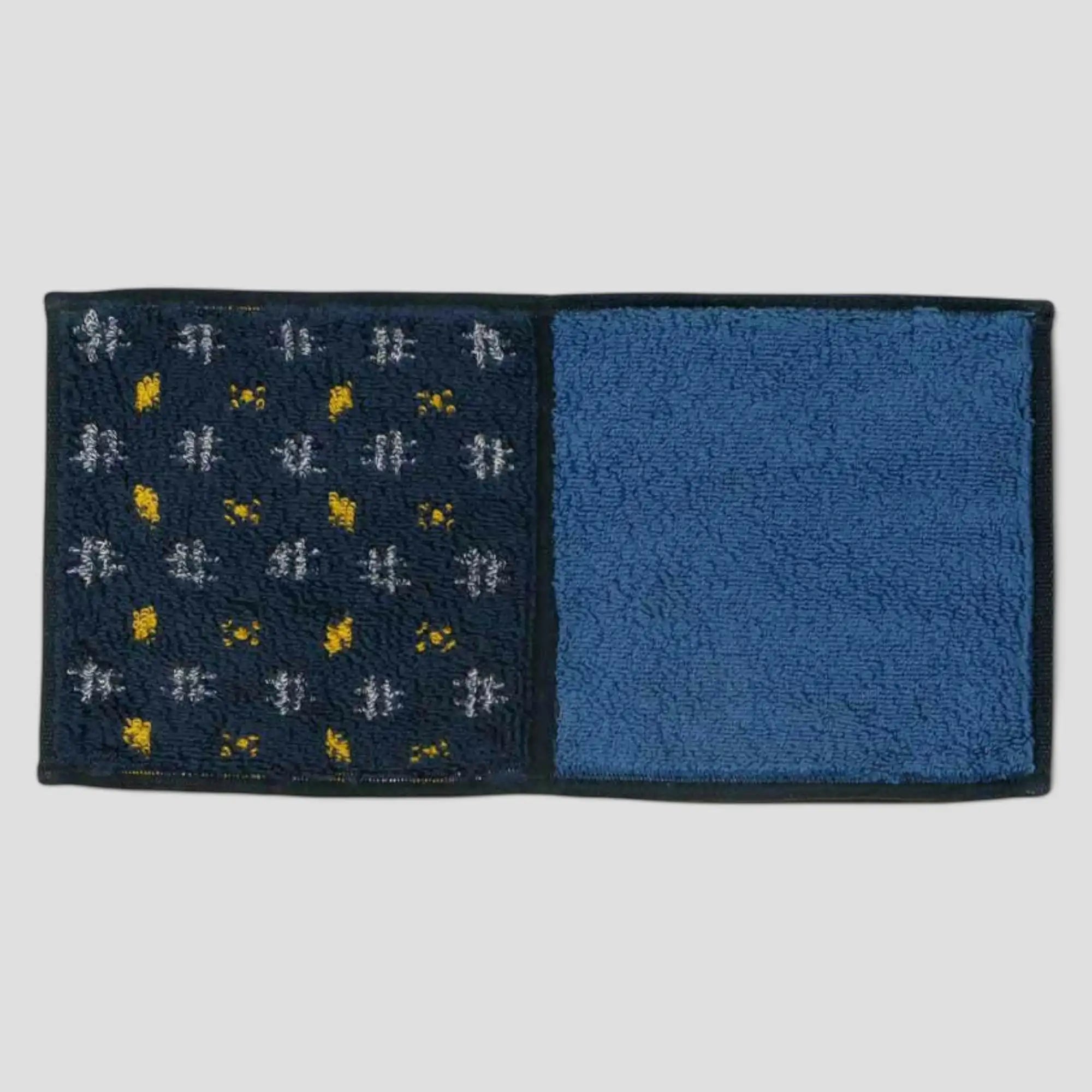 A Imabari towel in blue with yellow pattern, displayed against a white background.