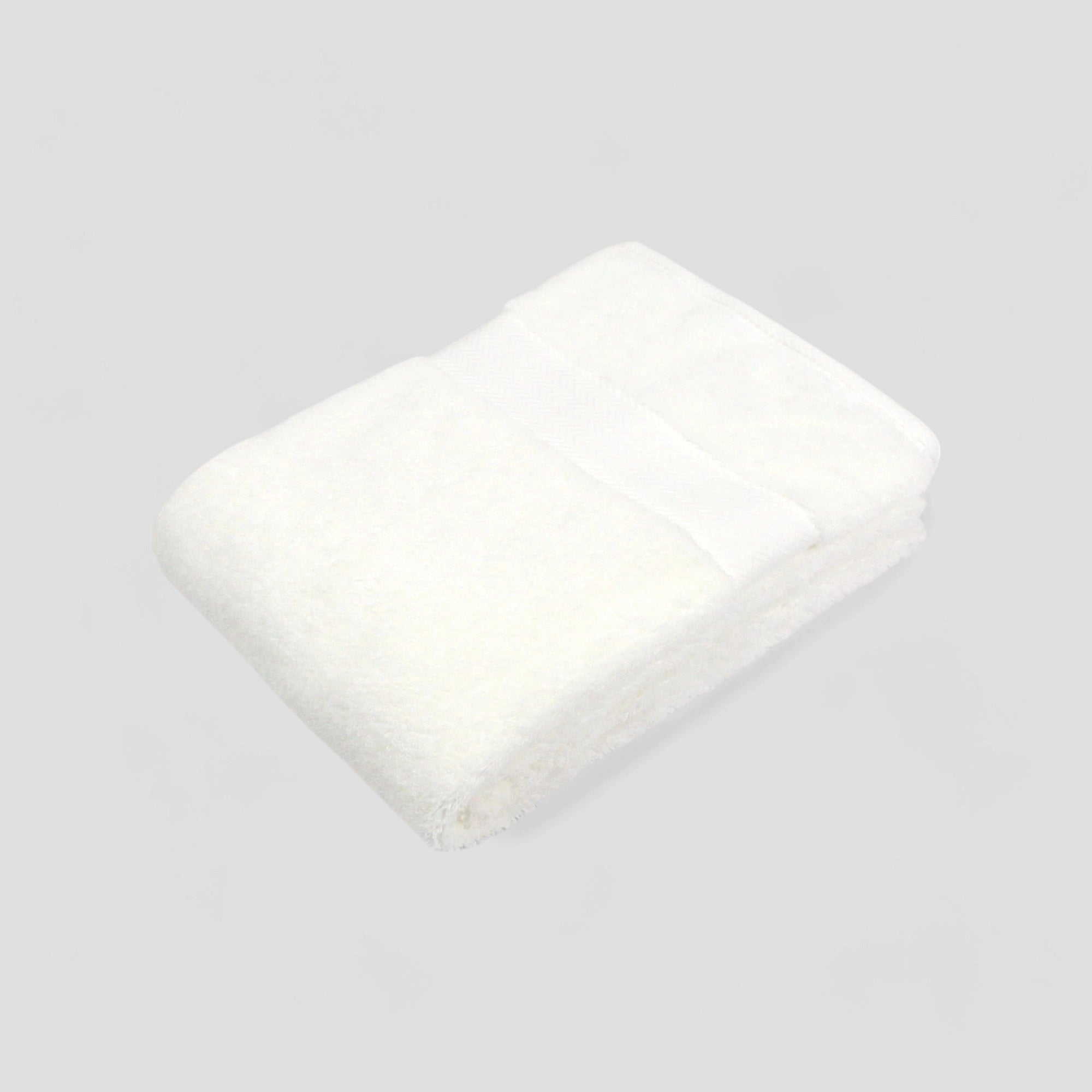 A stack of folded Imabari towels in white, pink, and blue colors made from pima cotton.