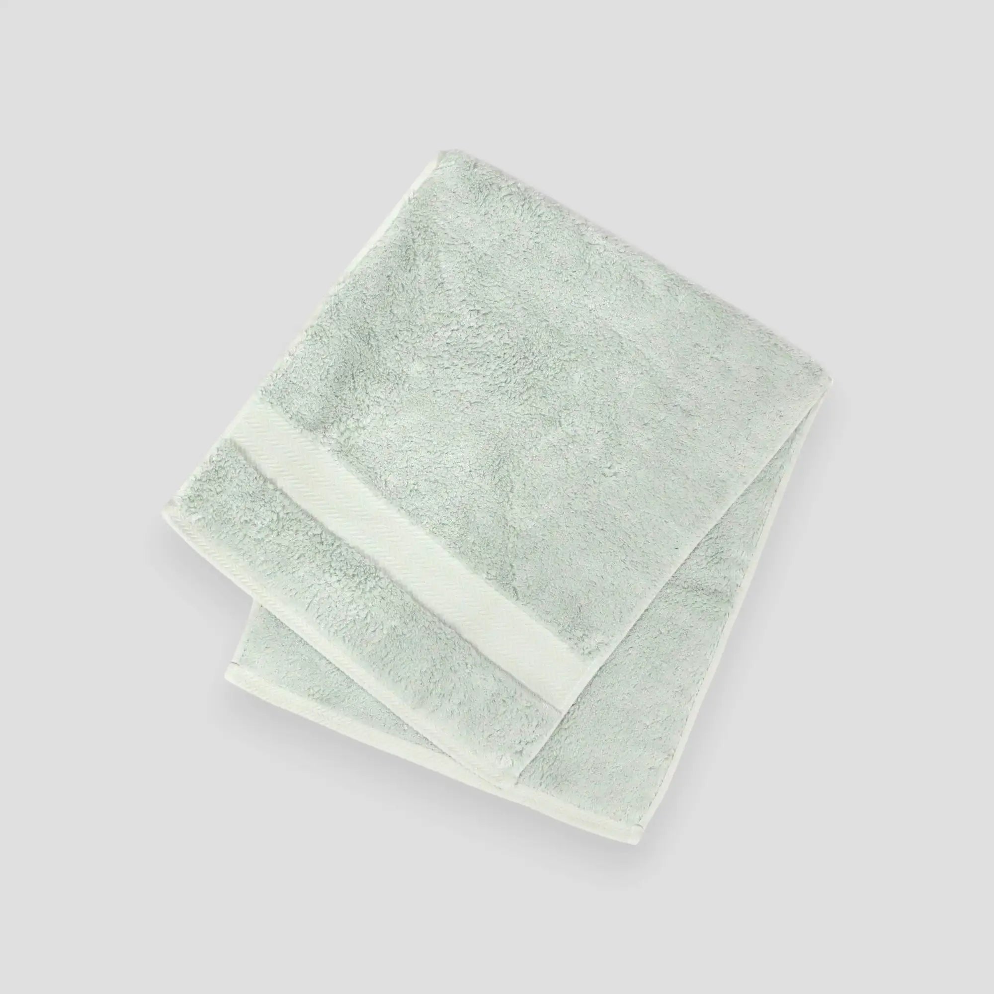A stack of folded Imabari towels in white, pink, and blue colors made from pima cotton.
