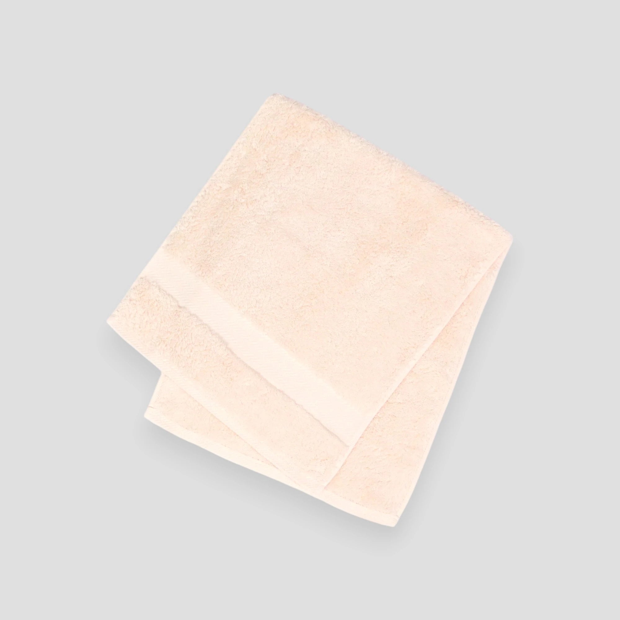 A stack of folded Imabari towels in white, pink, and blue colors made from pima cotton.