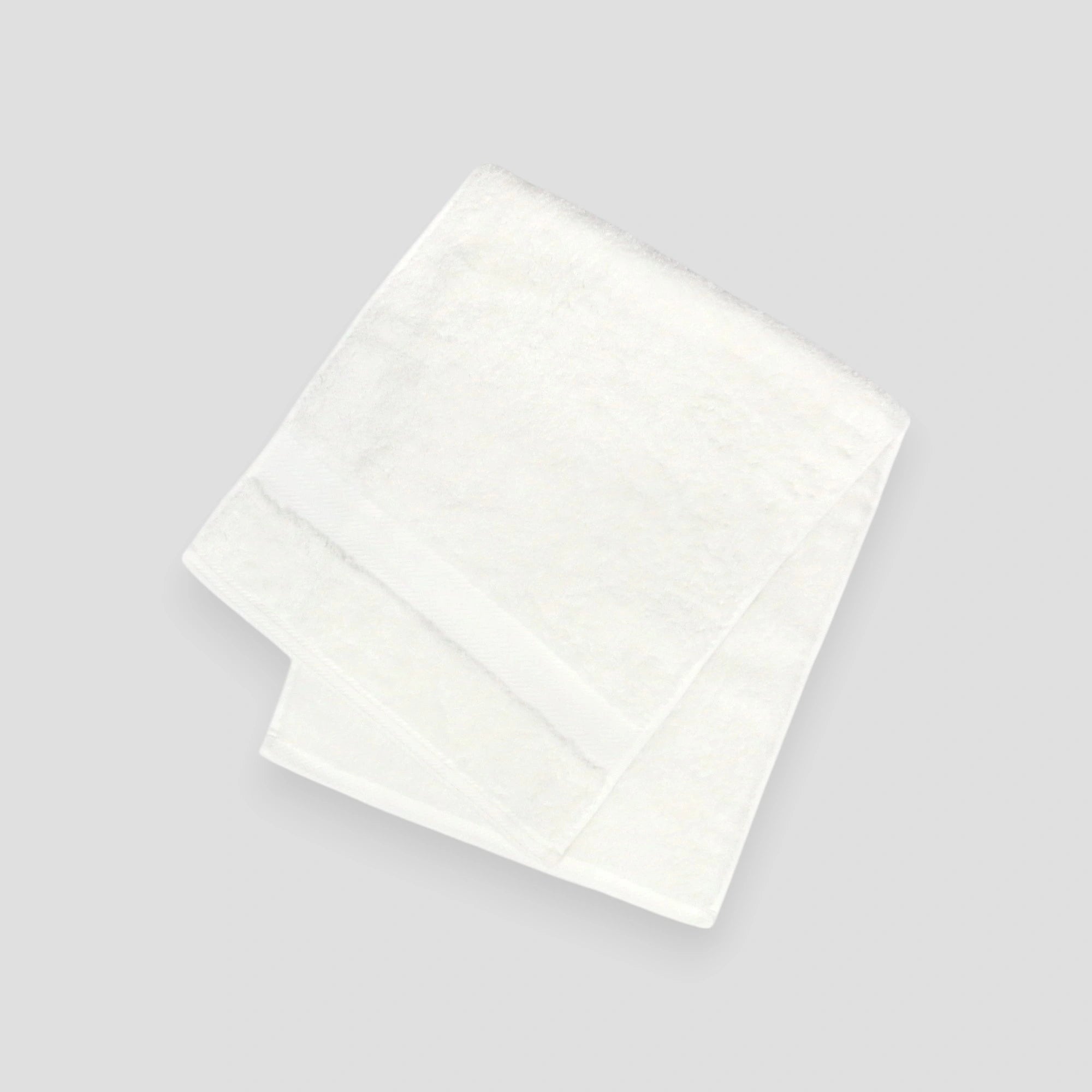 A stack of folded Imabari towels in white, pink, and blue colors made from pima cotton.