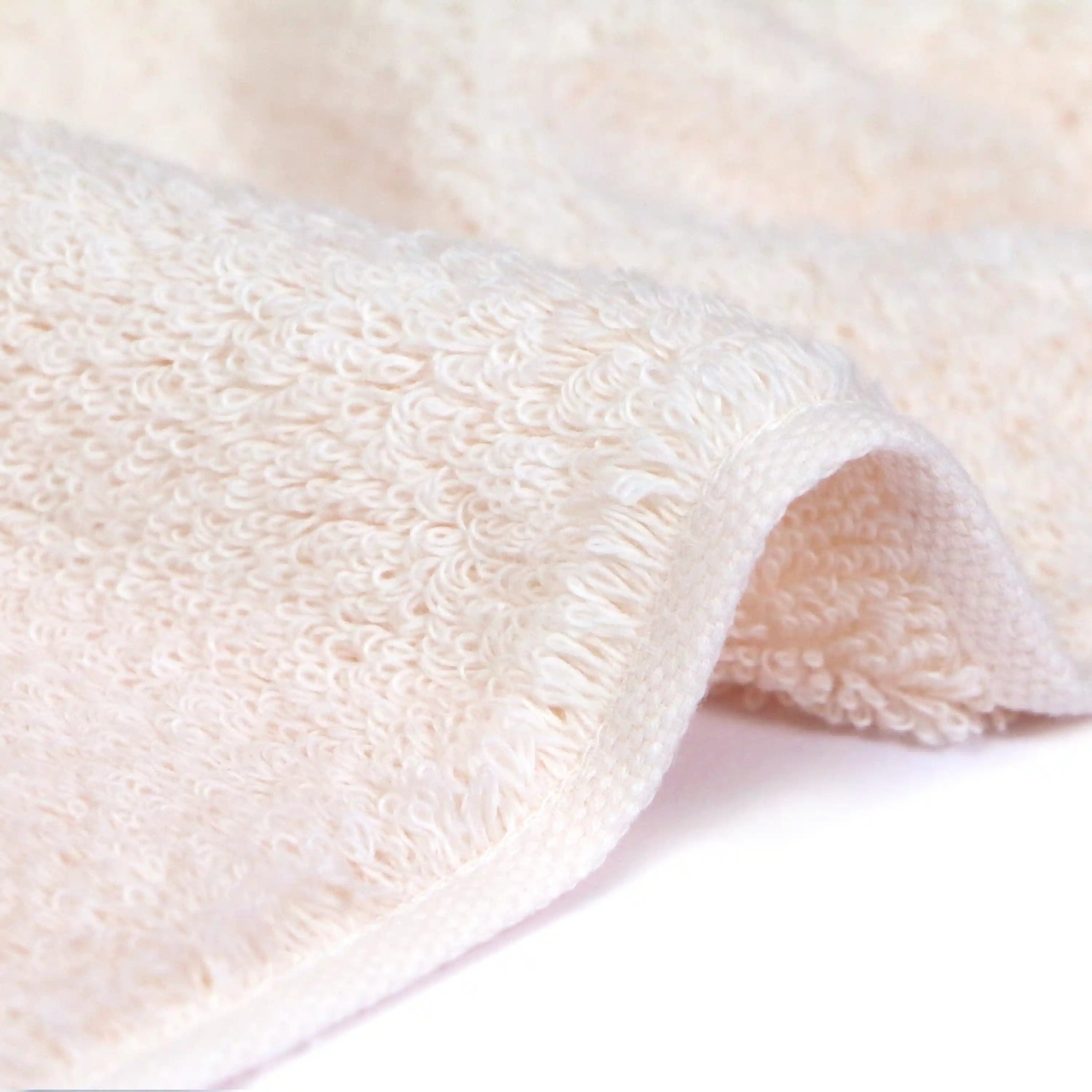 Side shot of the soft texture of the Iori Lotus premium Imabari bath towel in pink.
