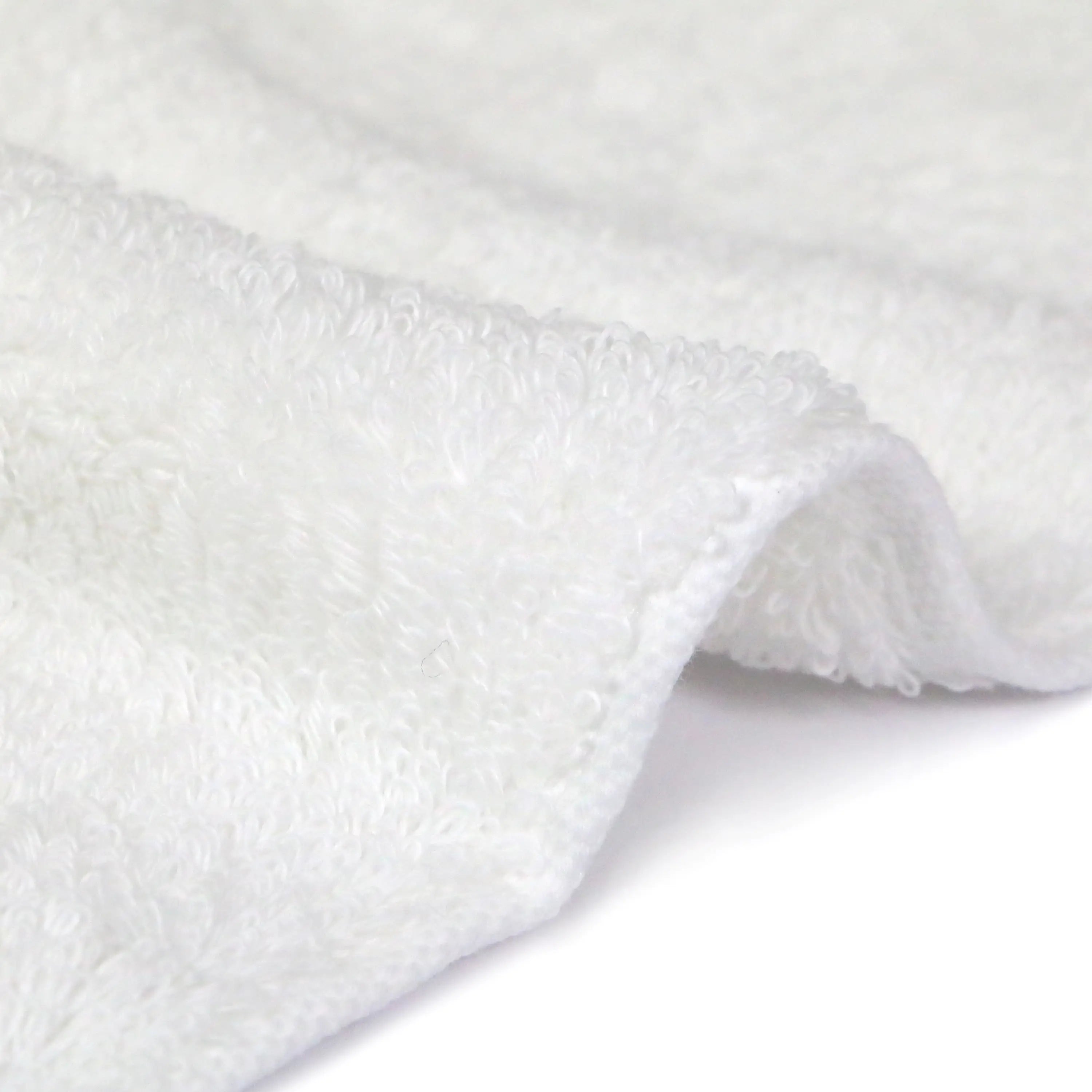 Side shot of the soft texture of the Iori Lotus premium Imabari bath towel in white.