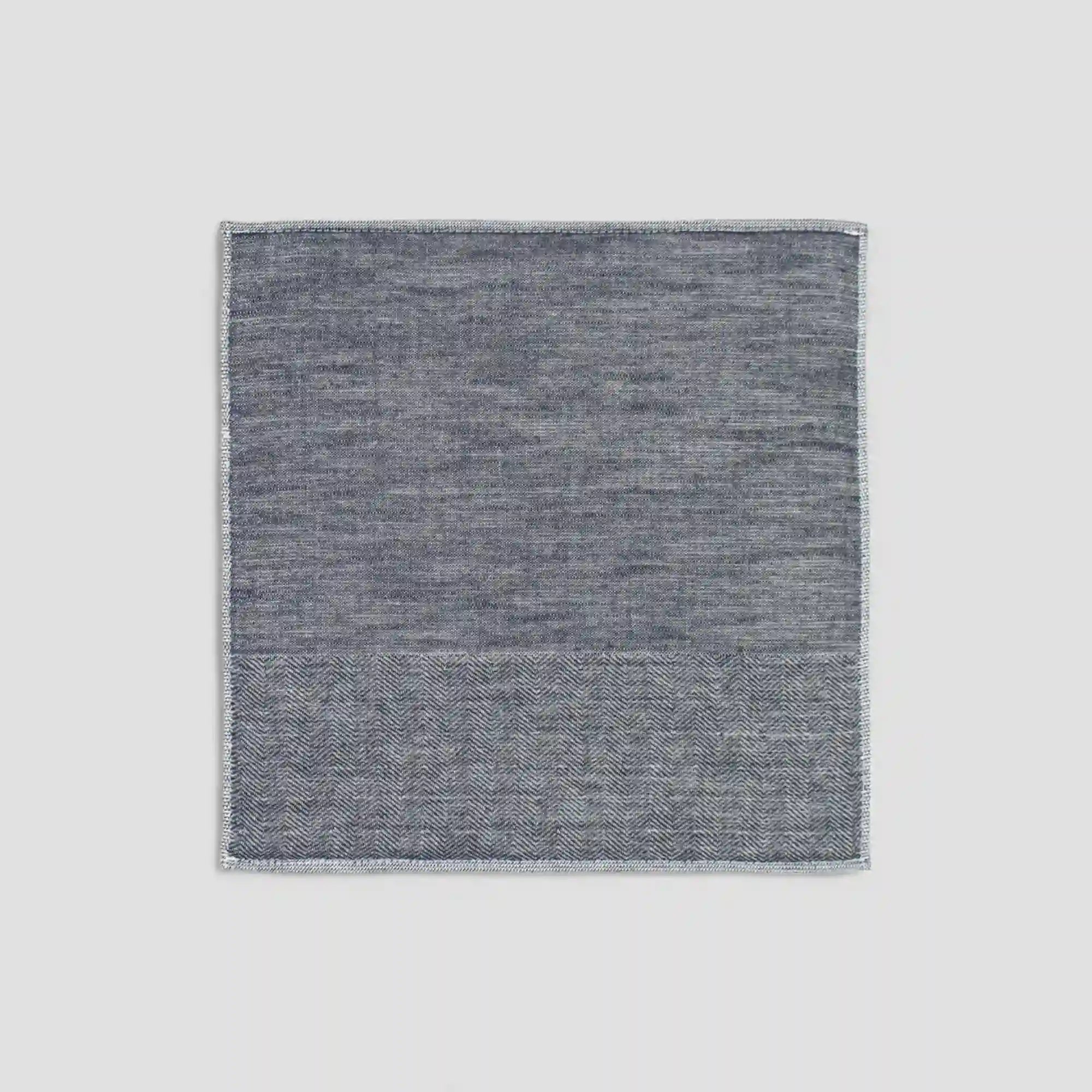 Navy Imabari towel with a subtle herringbone pattern on a light gray background.