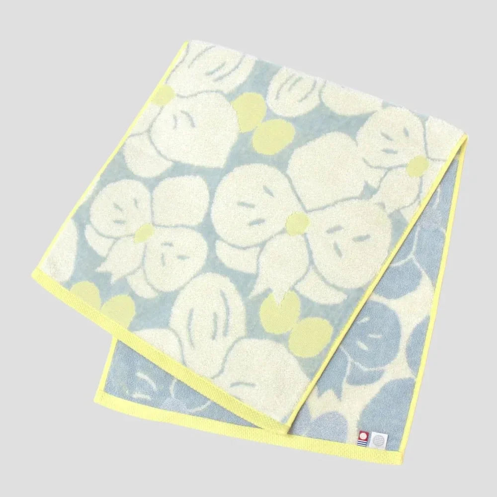 Imabari towel with white floral pattern, showing labels of Imabati towel brand mark and IORI&