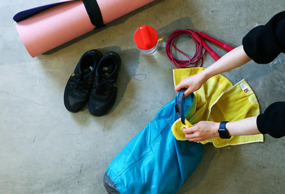 Putting a yellow Imabari towel in bag