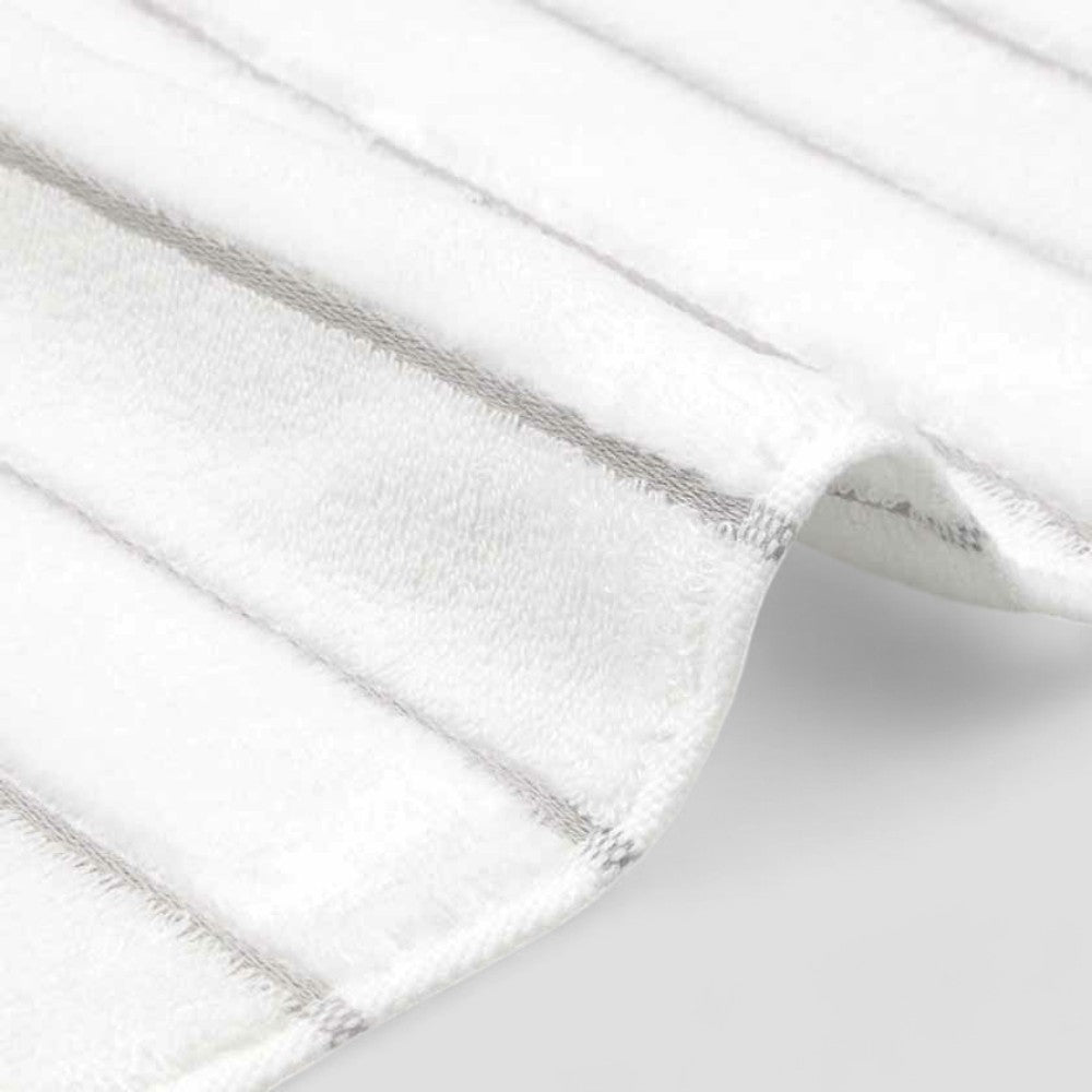 Close-up of the edge of white Imabari towel with gray stripe.