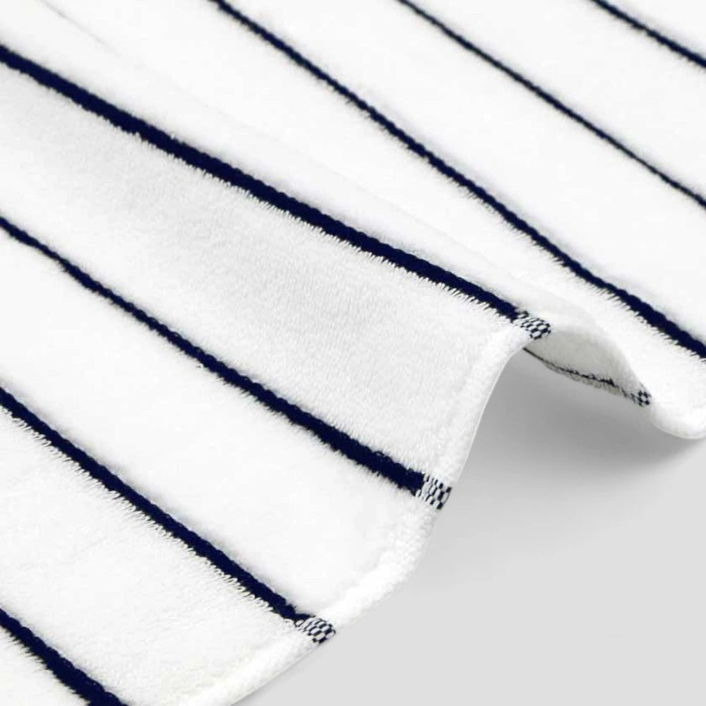 Close-up of the edge of white Imabari towel with navy stripe.