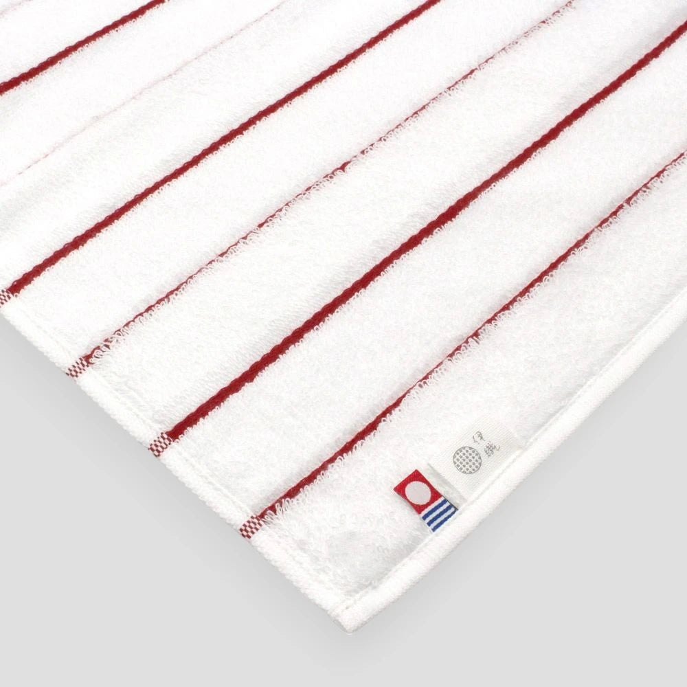 Close-up of the labels: Iambari towel brand mark and IORI&