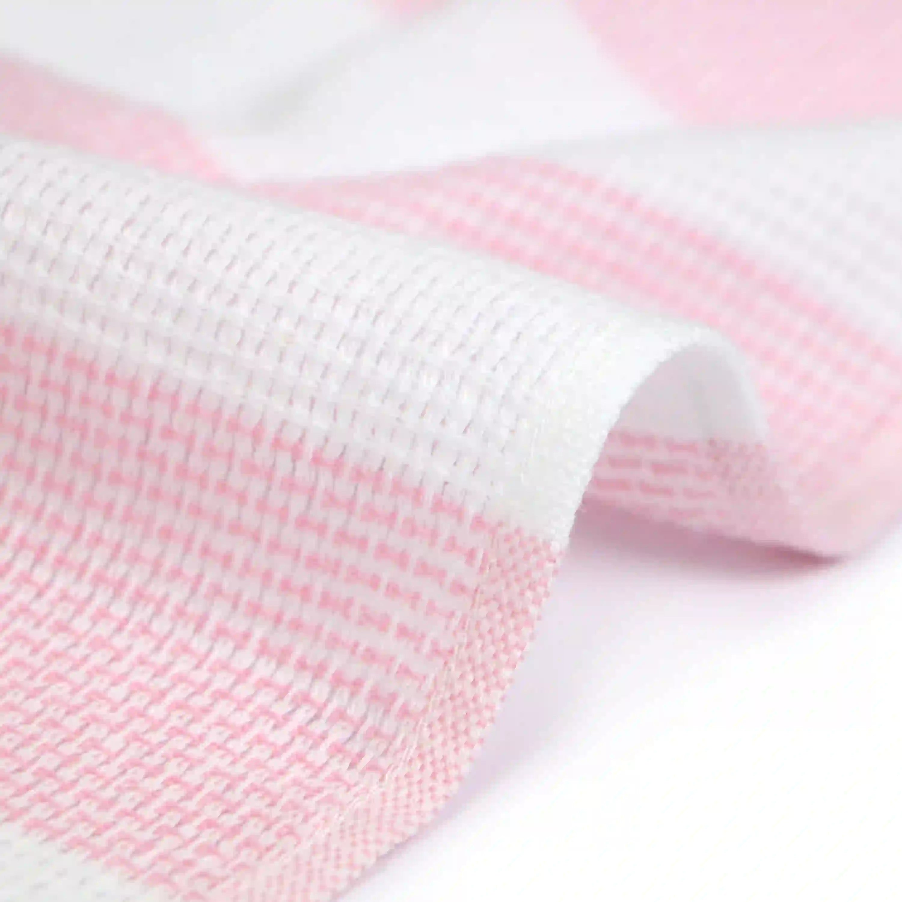 Close-up of a side of a Imabari towel wash cloth on pink pattern