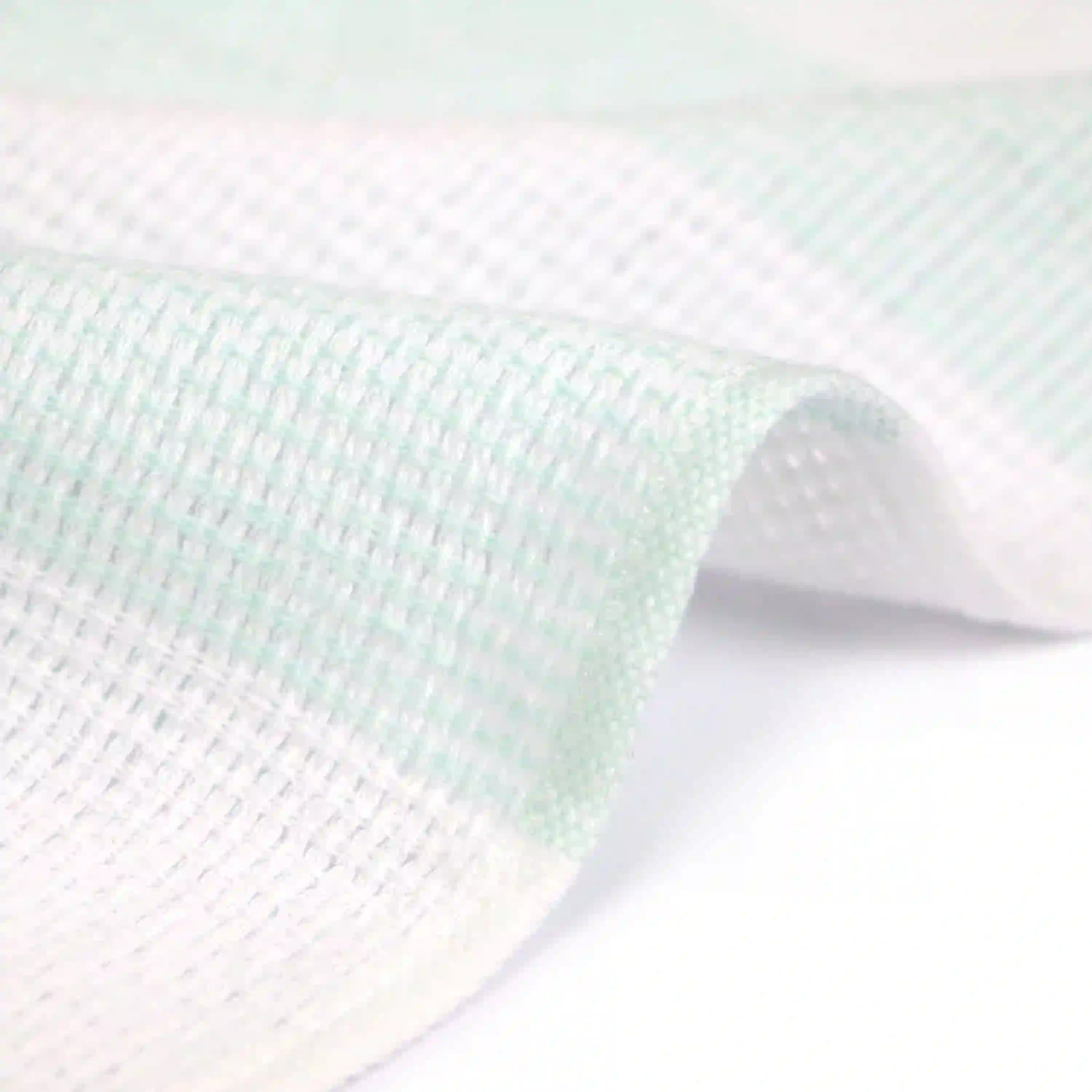 Close-up of a side of a Imabari towel wash cloth on green pattern
