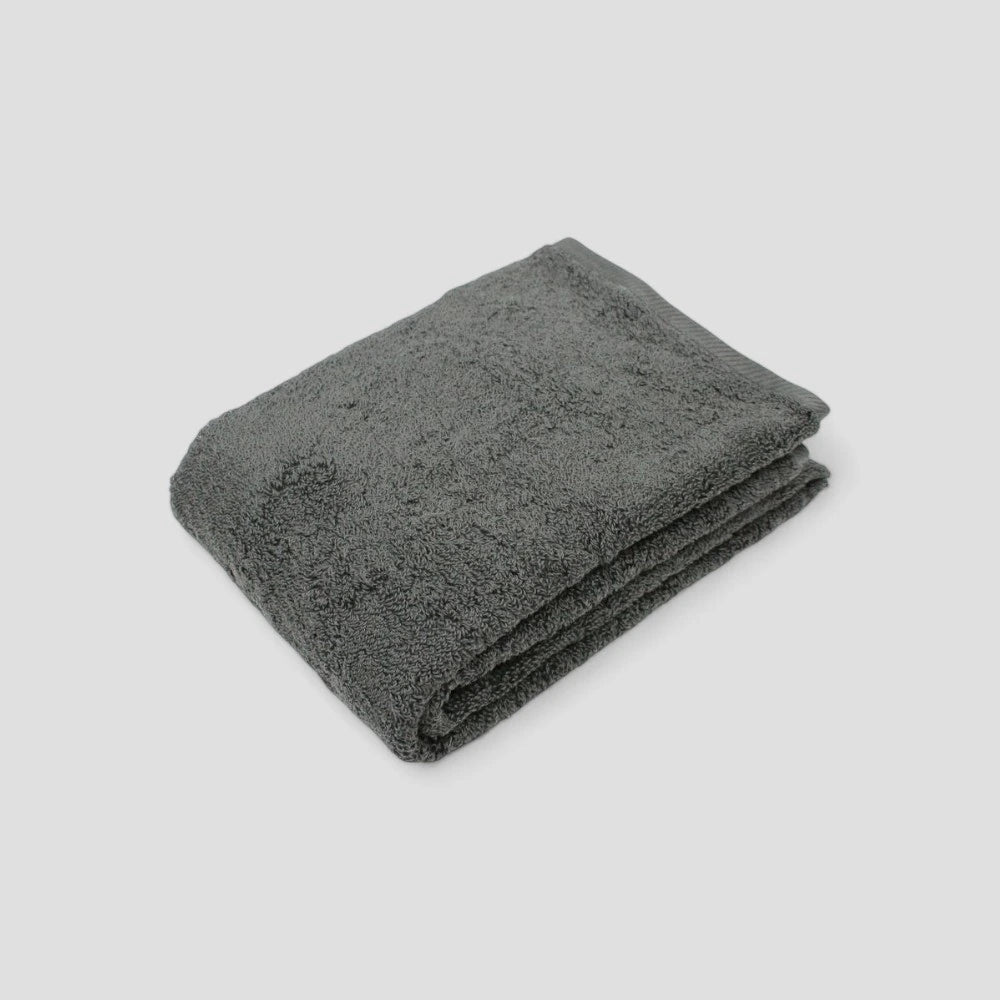 Folded dark-gray Imabari towel on the gray background