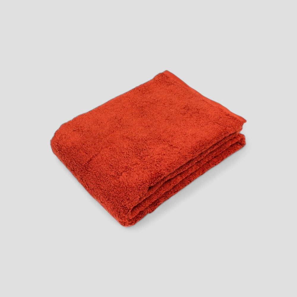 Folded red Imabari towel on the gray background