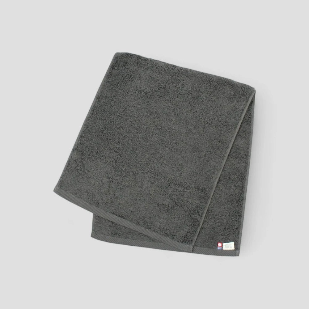 Folded gray Imabari towel showing brand labels