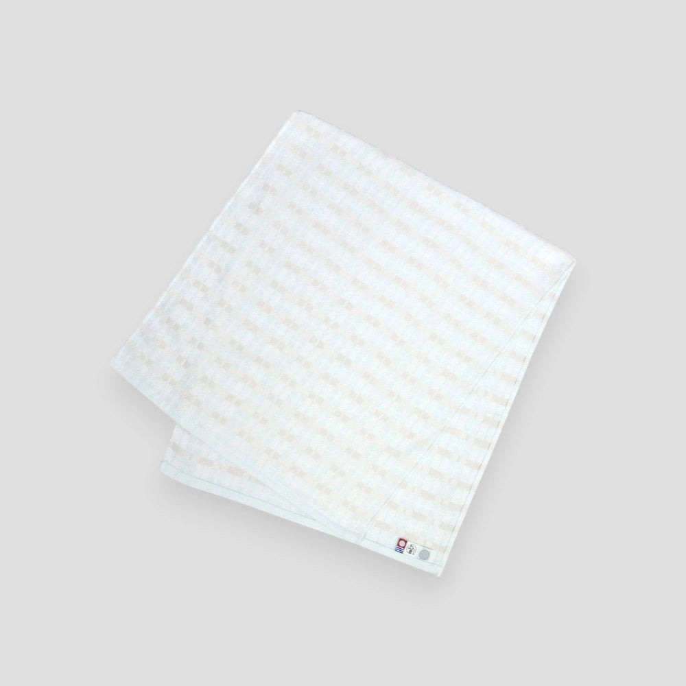 Blue folded ENOWA Imabari towel displayed against a white background, with the brand&