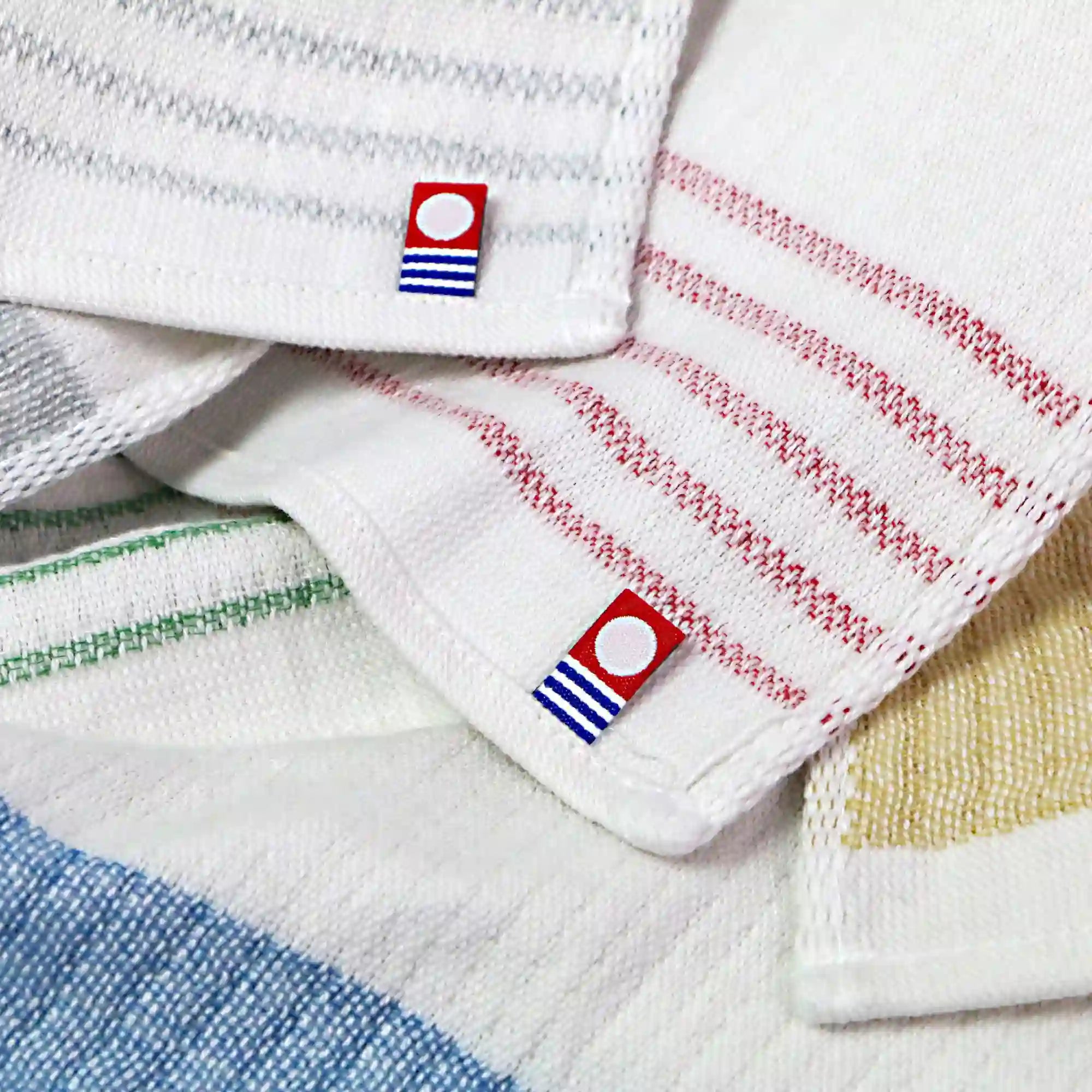 Close-up of labels of Imabari towel brand marks each colorful Imabari towel linen kitchen cloth