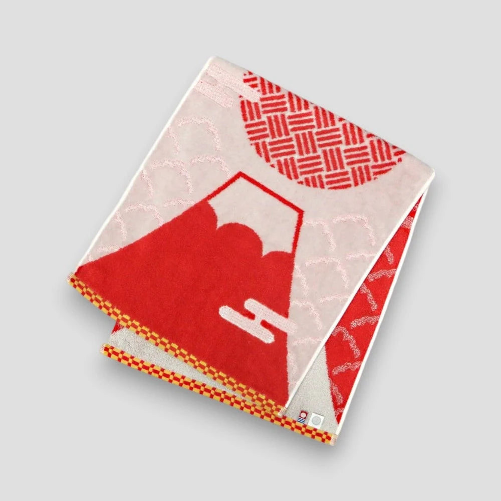 Folded Imabari towel featuring geometric and Mt. fuji patterns, with  red colors prominently displayed, on a white background.
