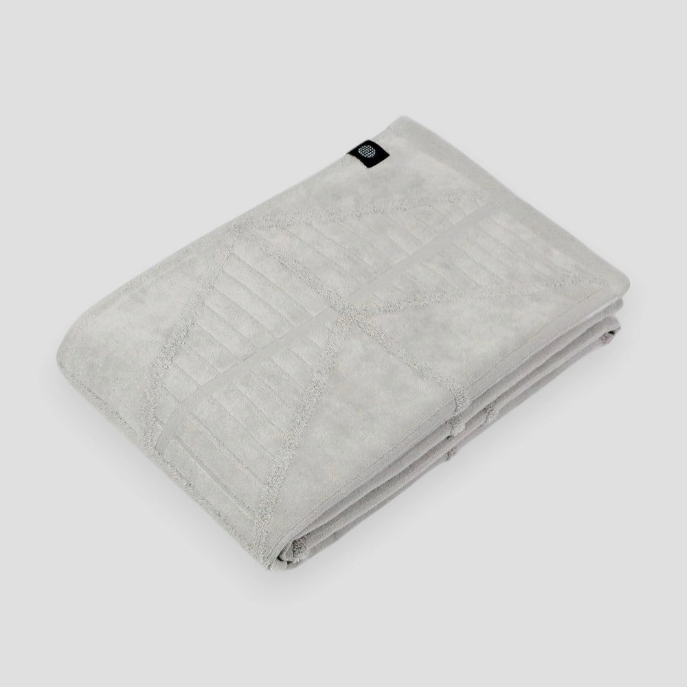 A folded gray Imabari towels on a light gray background