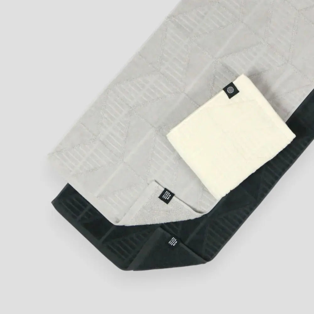 Three color Imabari towels with herringbone pattern on a light gray background