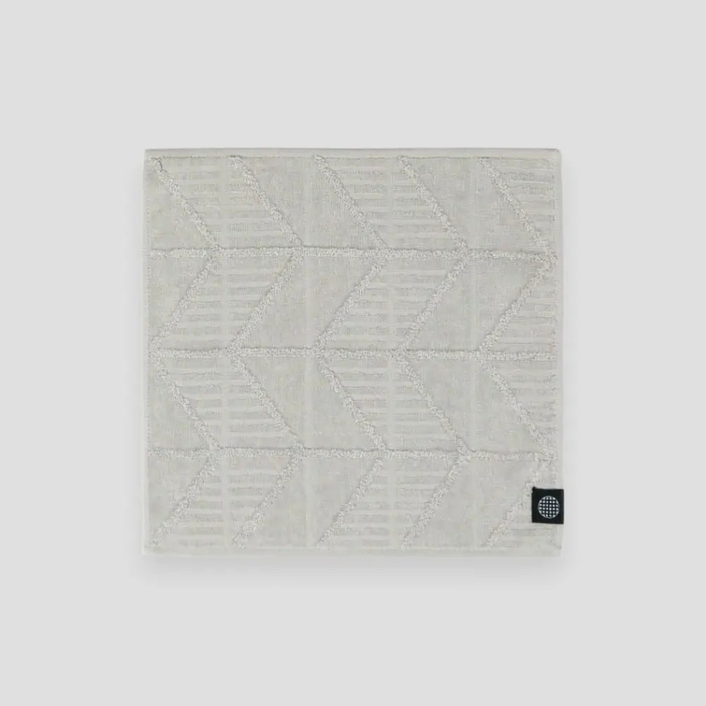 Gray Imabari towel with herringbone pattern on a light gray background