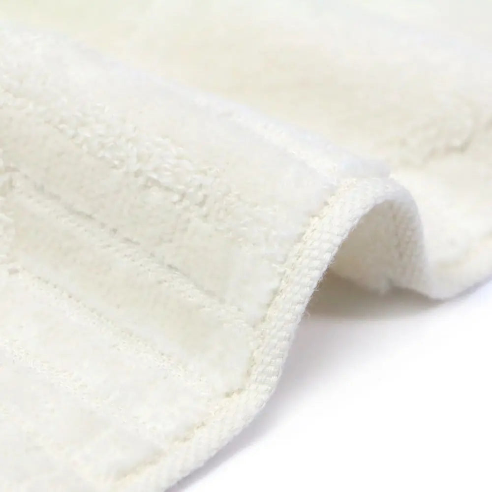 Close-up of a textured white Imabari towel  on a light gray background