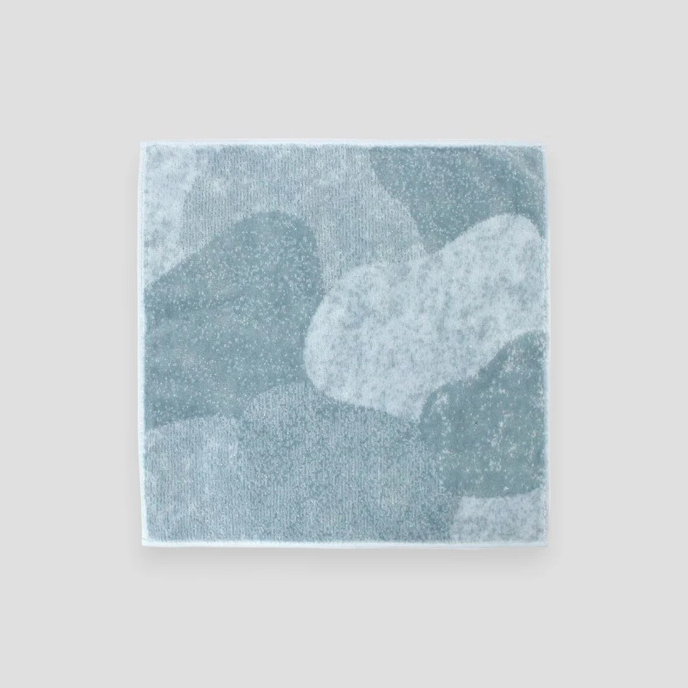 A Imabari towel in gray resembling stone laid out flat.