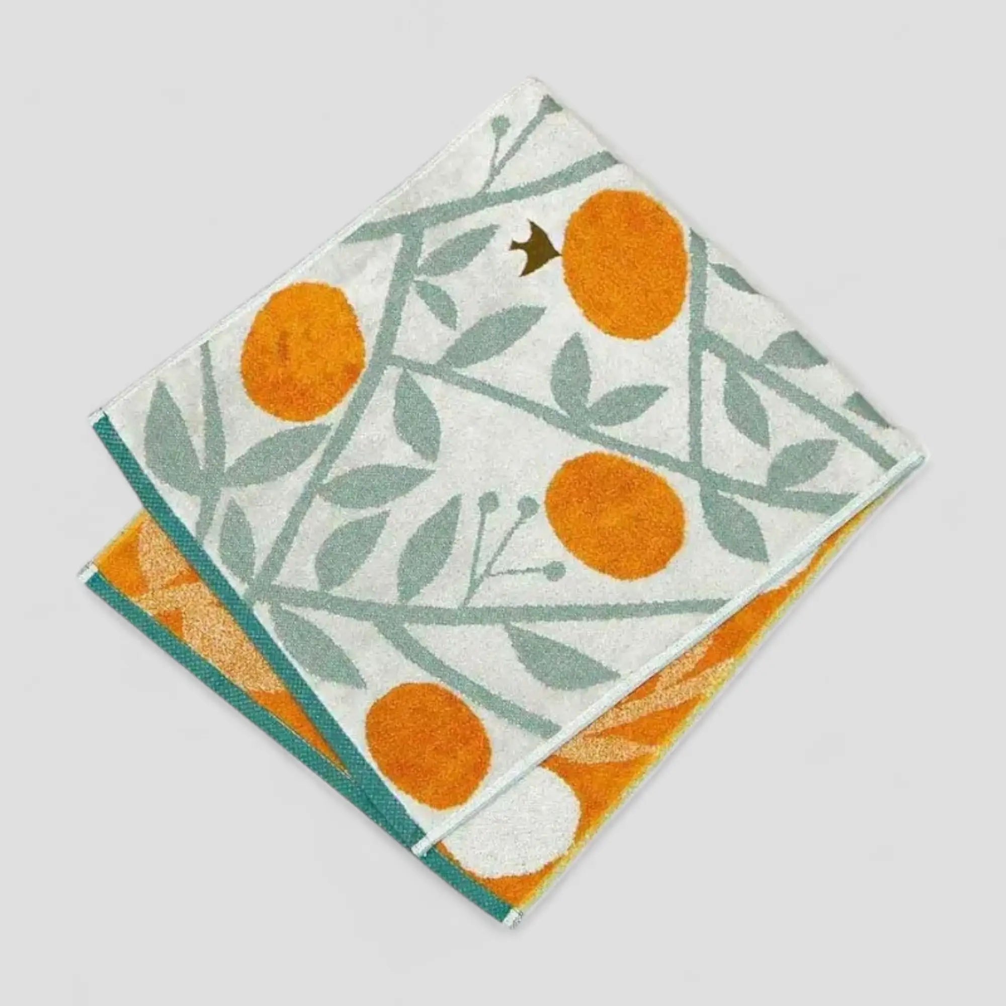 A multicolored Imabari towel with a bird, orange and leaf pattern 
