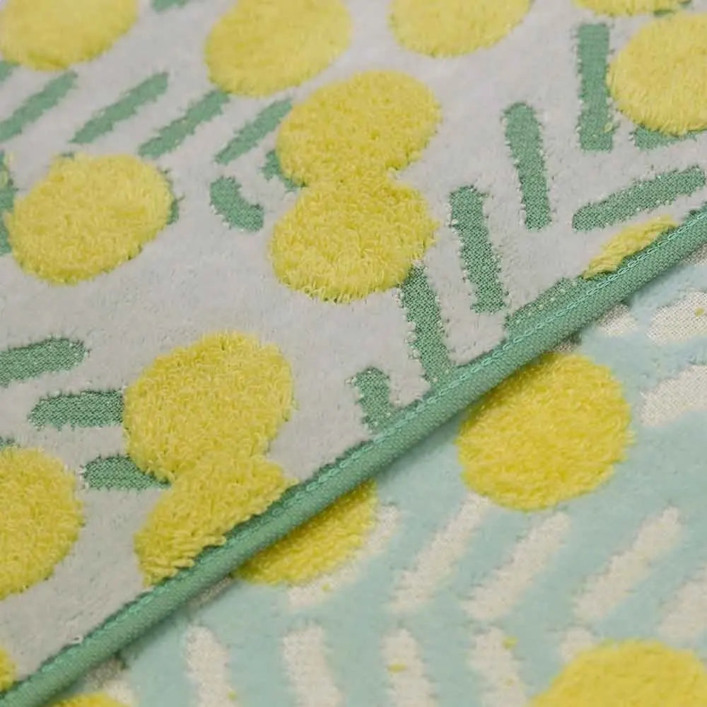 Close-up of texture of Imabari towel fabric  with yellow floral pattern in white and blue