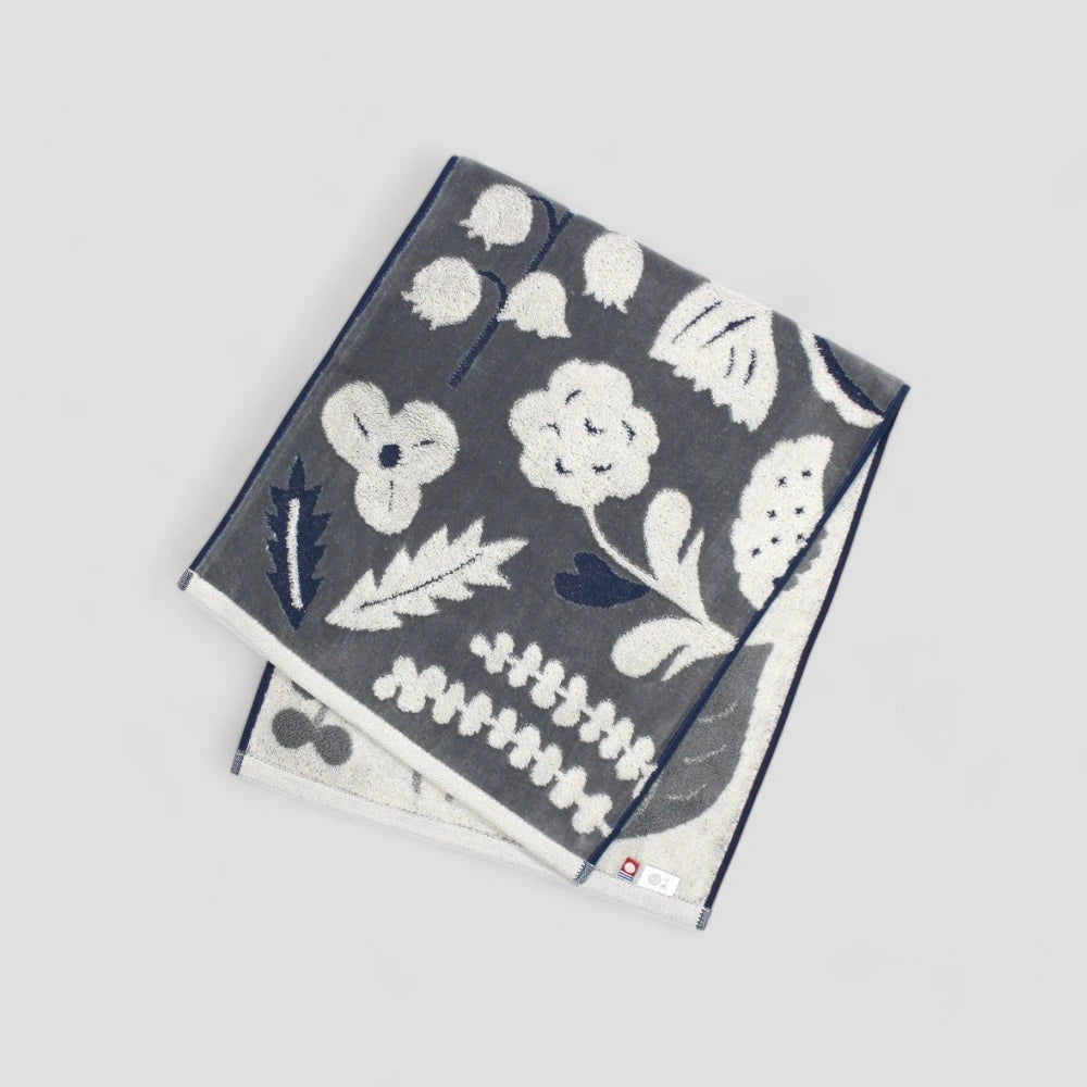 Dark gray Imabari towels with a white floral jacquard pattern 