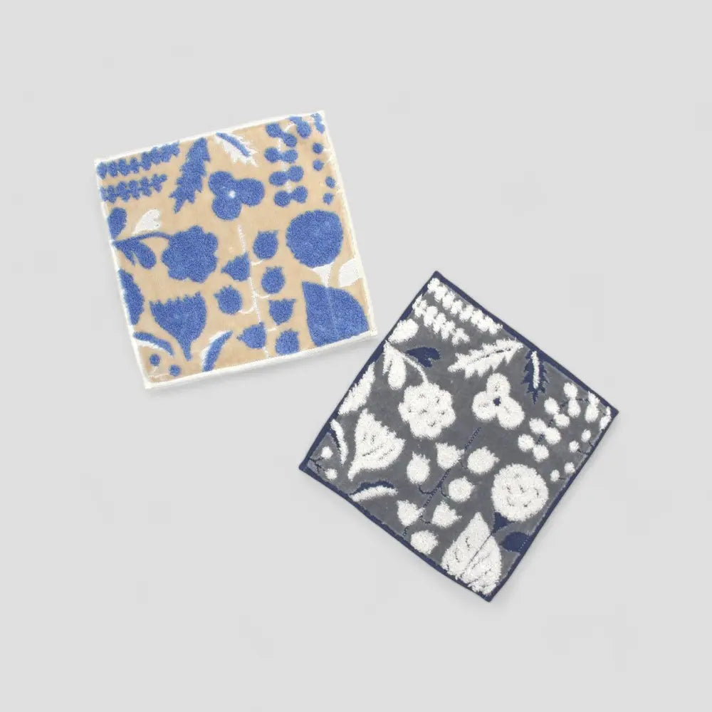A set of dark gray and beige square mabari towel with floral pattern