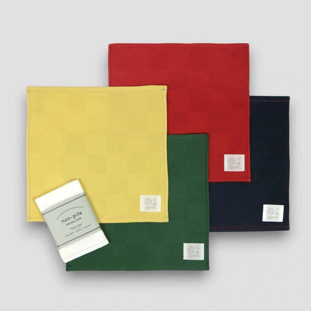 A collection of Non-Pile Imabari towels in yellow, red, green, and navy and white, displayed with packaging.