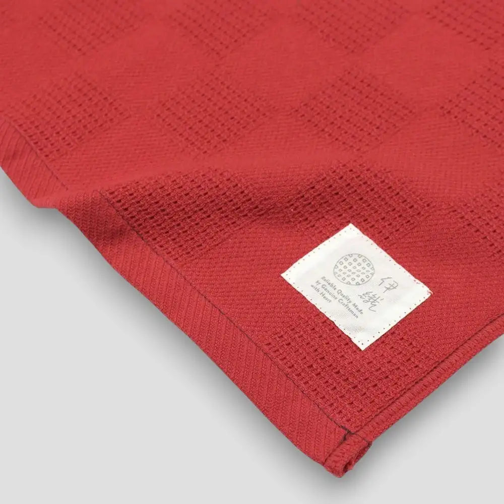A collection of Non-Pile Imabari towels in red with a brand logo.