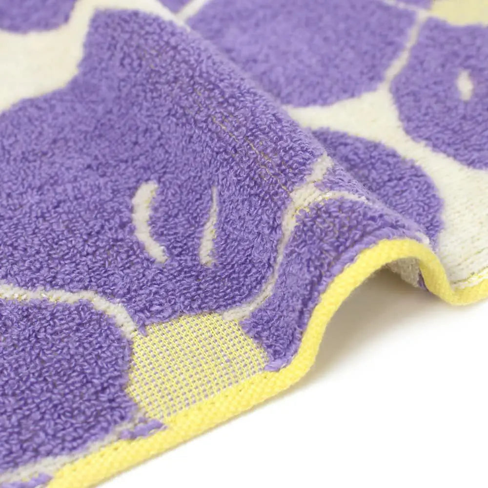 Close-up of a side Imabari towel with a purple floral motif