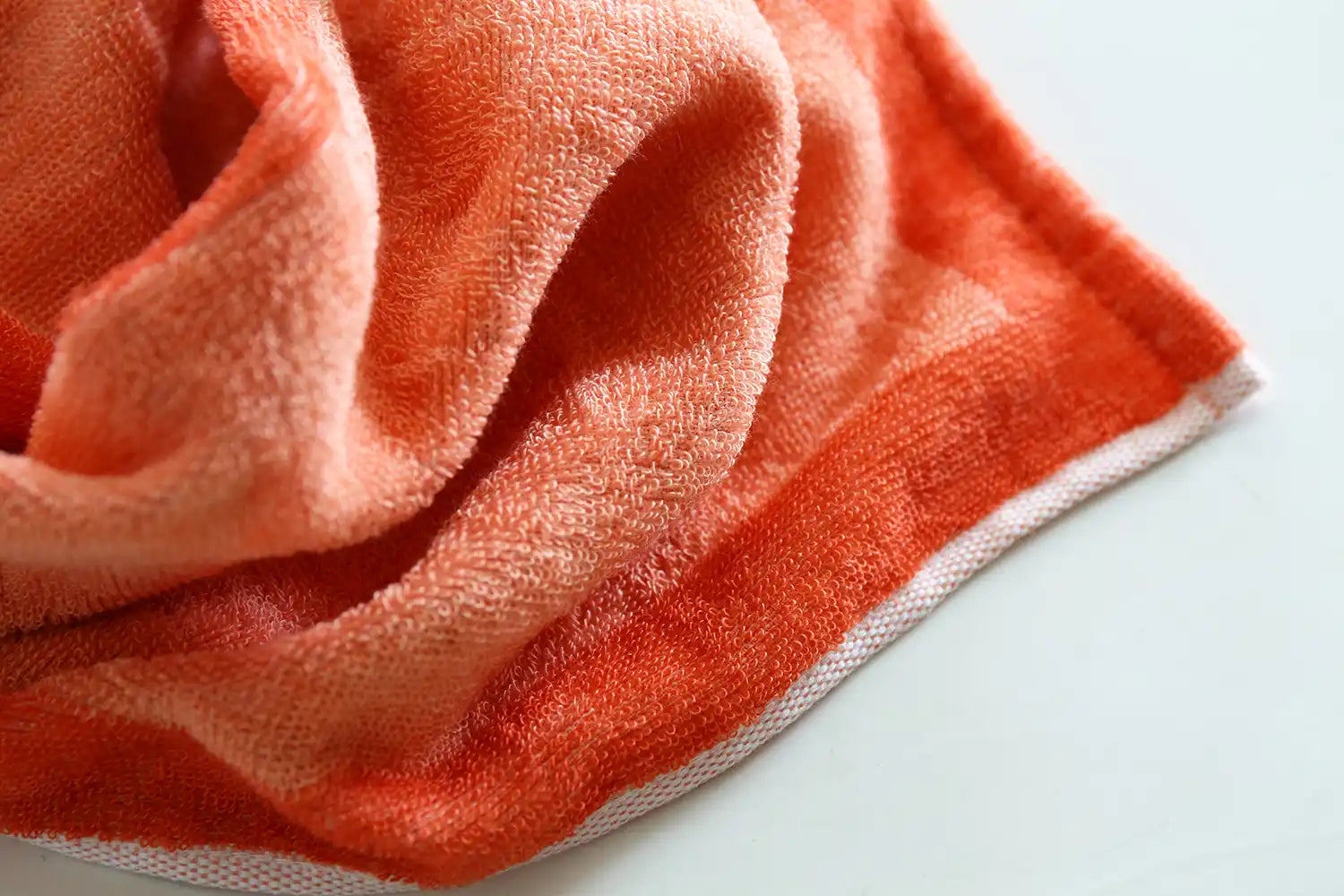 A close-up of the texture reversible orange Imabari towel