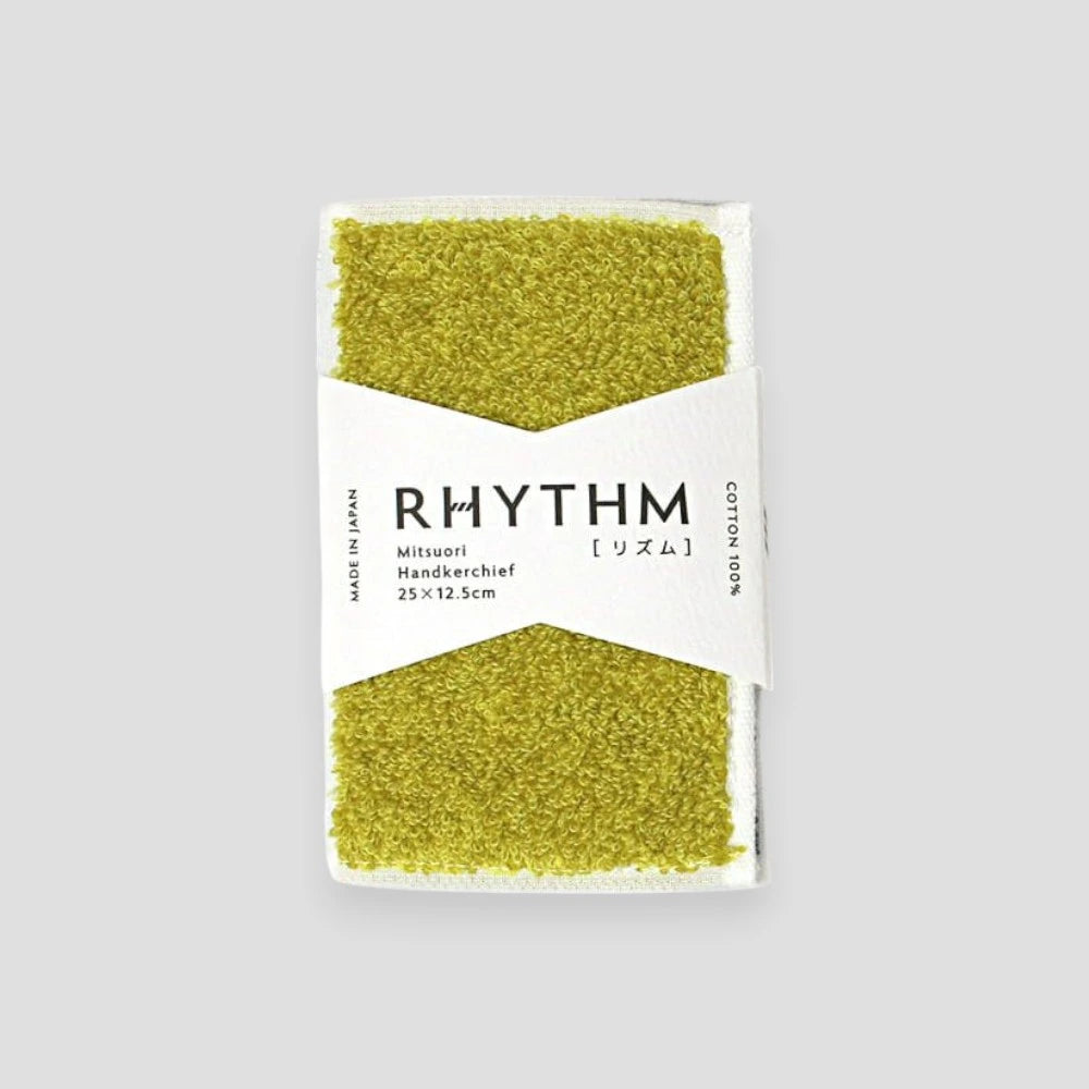 A yellow folded Imabari towel with white paper package series named "RHYTHM"