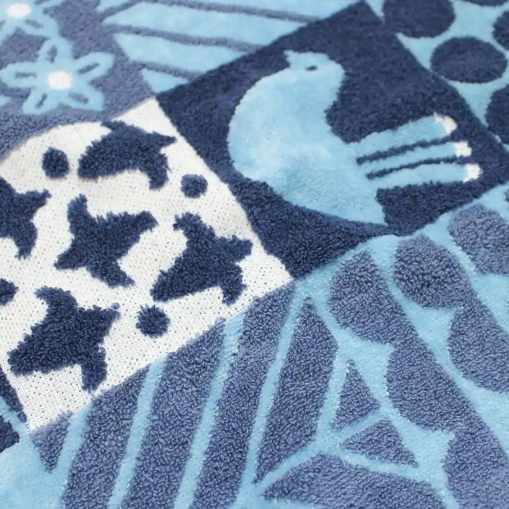 Close-up of a blue bird and floral patterned Imabari towel 