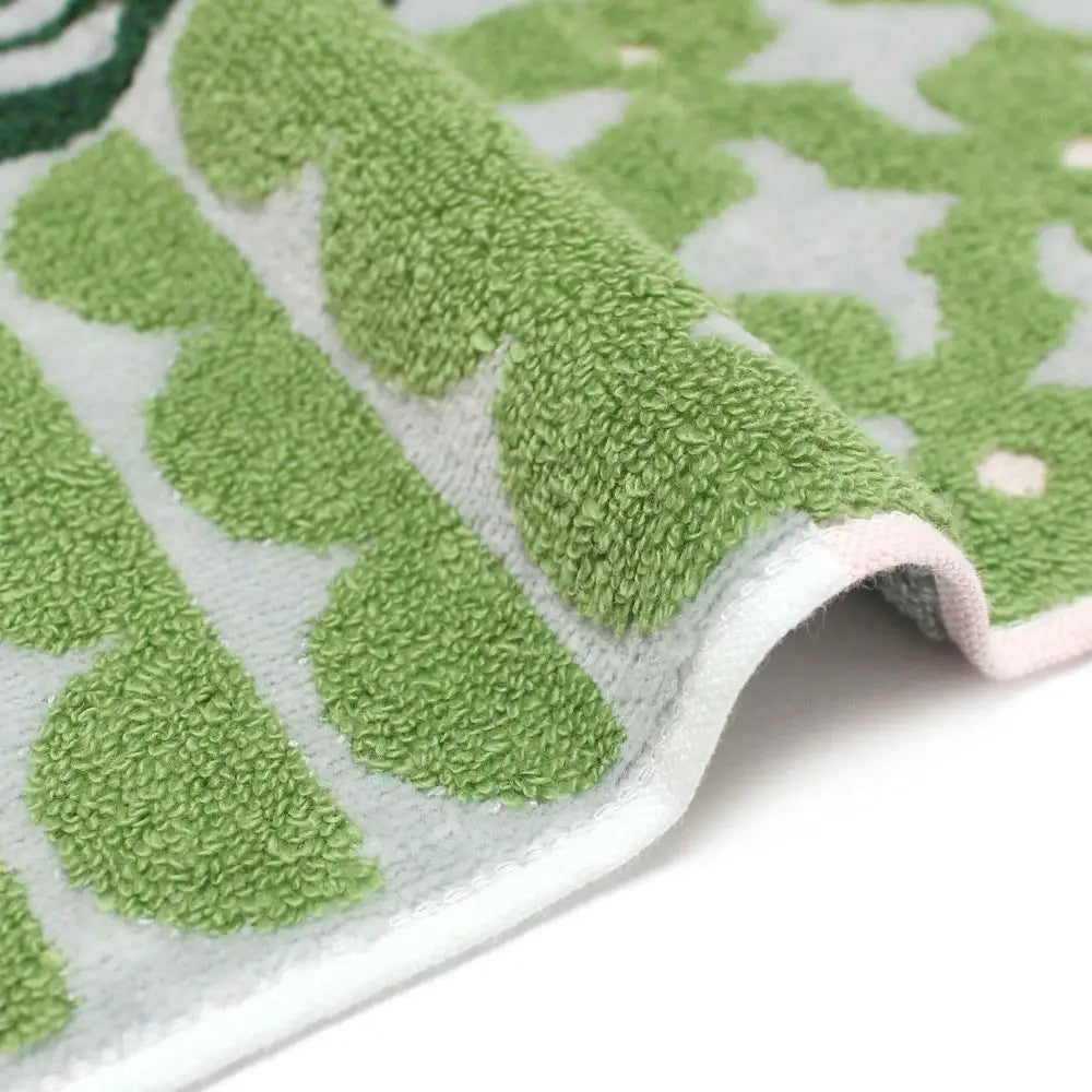 Close-up of a side of green patterned Imabari towel 