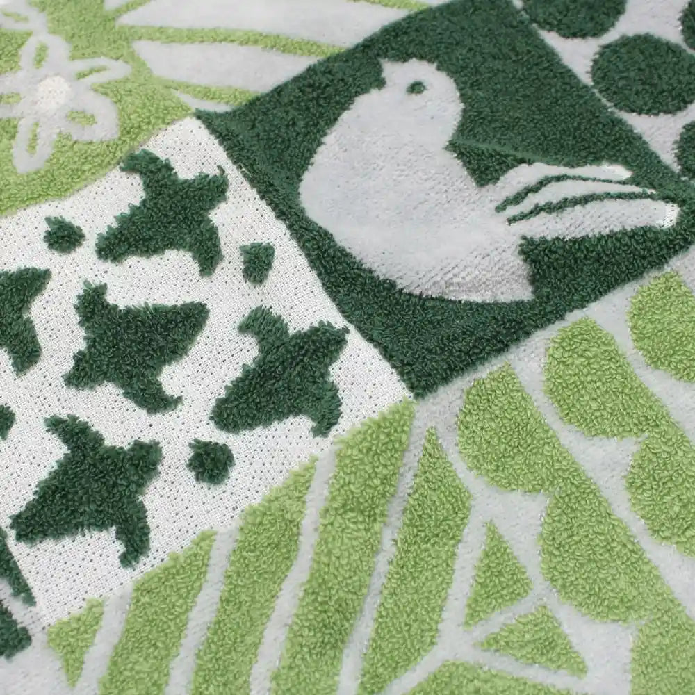 Close-up of a green bird and floral patterned Imabari towel 